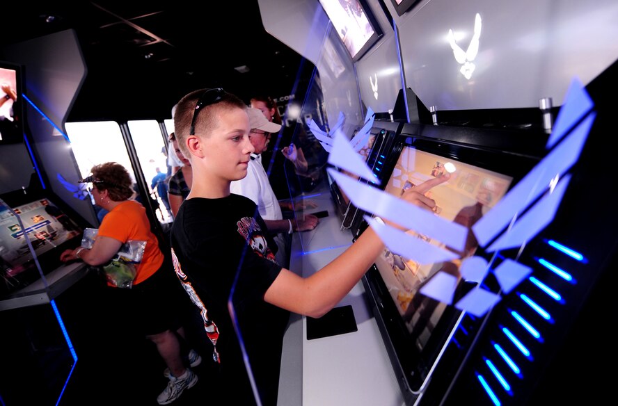 OFFUTT AIR FORCE BASE, Neb. - Cody Ray, an Omaha resident, walks through the Air Force recruiting display and uses touch screen panels to learn about the vast array of Air Force responsibilities Aug. 28 during the 2010 Defenders of Freedom Open House and Air Show. The show provided the local area community a rare chance to not only see aircraft up close but also to meet with military members. U.S. Air Force photo by Josh Plueger