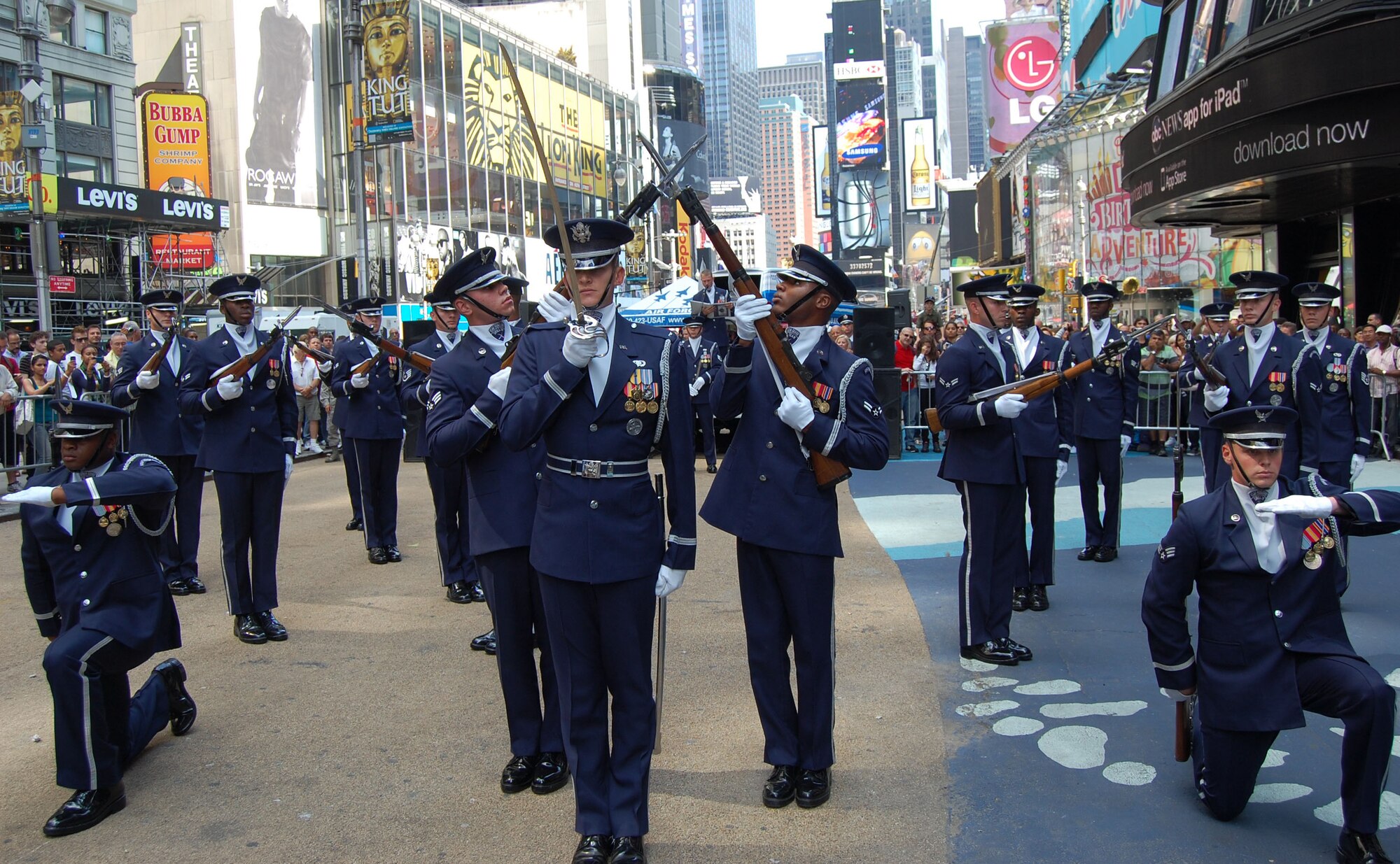 The Air Force Drill Team from Bolling AFB, Washington, D.C., performs their sophisticated skills of precision rifle work in Times Square Aug. 26, 2010, during Air Force Week in New York City. After an appearance on the “Good Morning America” show, 313th Recruiting Squadron members went to Times Square where they conducted a Delayed Enlistment Program swear-in and a promotion ceremony. Air Force Recruiting assets on hand included the Engage Tour, Command Center Alpha, two Air Force Monster Trucks and the Orange County Chopper. “We're proud to showcase America's Air Force here in Times Square,” said Lt. Col. Robert D. Roy, 313th RCS commander. (U.S. Air Force photo/Master Sgt. Steve Acevedo)