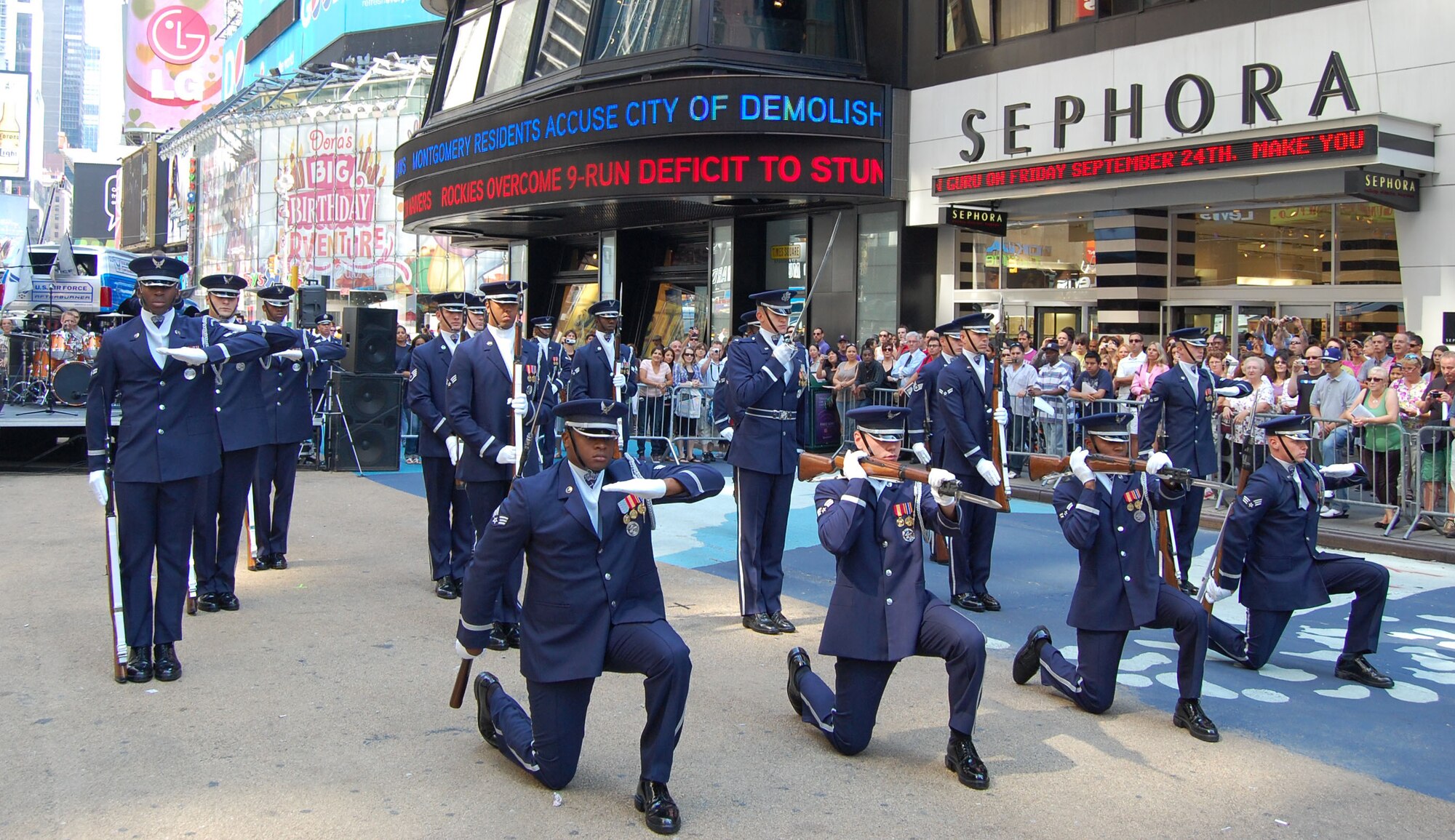 The Air Force Drill Team from Bolling AFB, Washington, D.C., performs their sophisticated skills of precision rifle work in Times Square Aug. 26, 2010, during Air Force Week in New York City. After an appearance on the “Good Morning America” show, 313th Recruiting Squadron members went to Times Square where they conducted a Delayed Enlistment Program swear-in and a promotion ceremony. Air Force Recruiting assets on hand included the Engage Tour, Command Center Alpha, two Air Force Monster Trucks and the Orange County Chopper. “We're proud to showcase America's Air Force here in Times Square,” said Lt. Col. Robert D. Roy, 313th RCS commander. (U.S. Air Force photo/Master Sgt. Steve Acevedo)