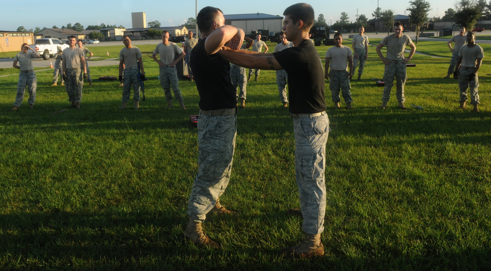 MOODY AIR FORCE BASE, Ga. --Senior Airman Thomas Meadows, 822nd Security Forces Squadron squad leader and Krav Maga instructor, explains how to escape a choke hold as Airman 1st Class Dylan Vankerchkhoven, 822nd Security Forces Squadron fire team member and Krav Maga instructor, assist in the demonstration as the attacker here Aug. 20. During this session of training, 822nd SFS members were being trained on choke defense and weapon take away. (U.S. Air Force photo/ Airman 1st Class Benjamin Wiseman)
