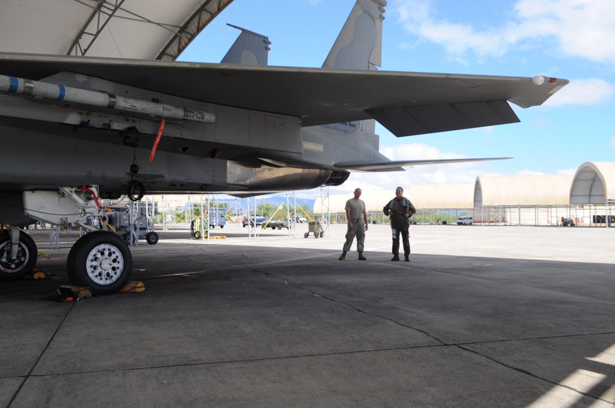 JOINT BASE PEARL HARBOR-HICKAM, Hawaii - F-15 Eagle crew chief, Airman First Class David Lairsey and pilot, Lt. Col Mark "Odie" Ladtkow of the 199th Fighter Squadron, Hawaii Air National Guard, Joint Base Pearl Harbor-Hickam, conduct a visual inspection before Colonel Ladtkow's last F-15 training mission on Aug. 25 at Hickam. The 199th is transitioning from the F-15 to the F-22 Raptor, which is a fifth generation fighter. The 199th has flown the F-15 since 1987 and received their first two Raptors on July 9, 2010.  (U.S.  Air Force photo/Tech Sgt. Cohen A. Young)