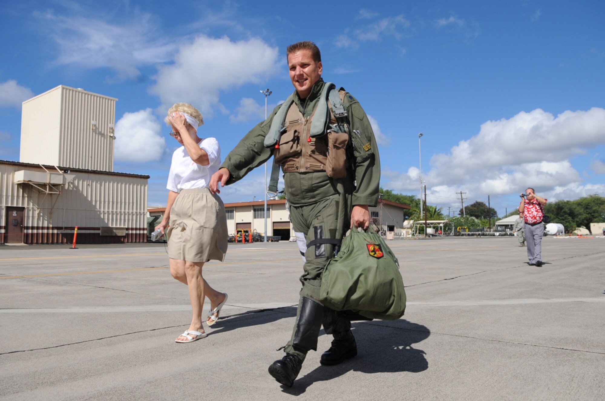 JOINT BASE PEARL HARBOR-HICKAM, Hawaii - Laura Ladtkow walks on the flightline with her son Lt. Col Mark "Odie" Ladtkow of the 199th Fighter Squadron, Hawaii Air National Guard, Joint Base Pearl Harbor-Hickam, Hawaii as he prepares for his last F-15 training mission on Aug. 25 at Hickam. The 199th is transitioning from the F-15 to the F-22 Raptor, which is a fifth generation fighter. The 199th has flown the F-15 since 1987 and received their first two Raptors on July 9, 2010.  (U.S.  Air Force photo/Tech Sgt. Cohen A. Young)Force photo/Tech Sgt. Cohen A. Young)