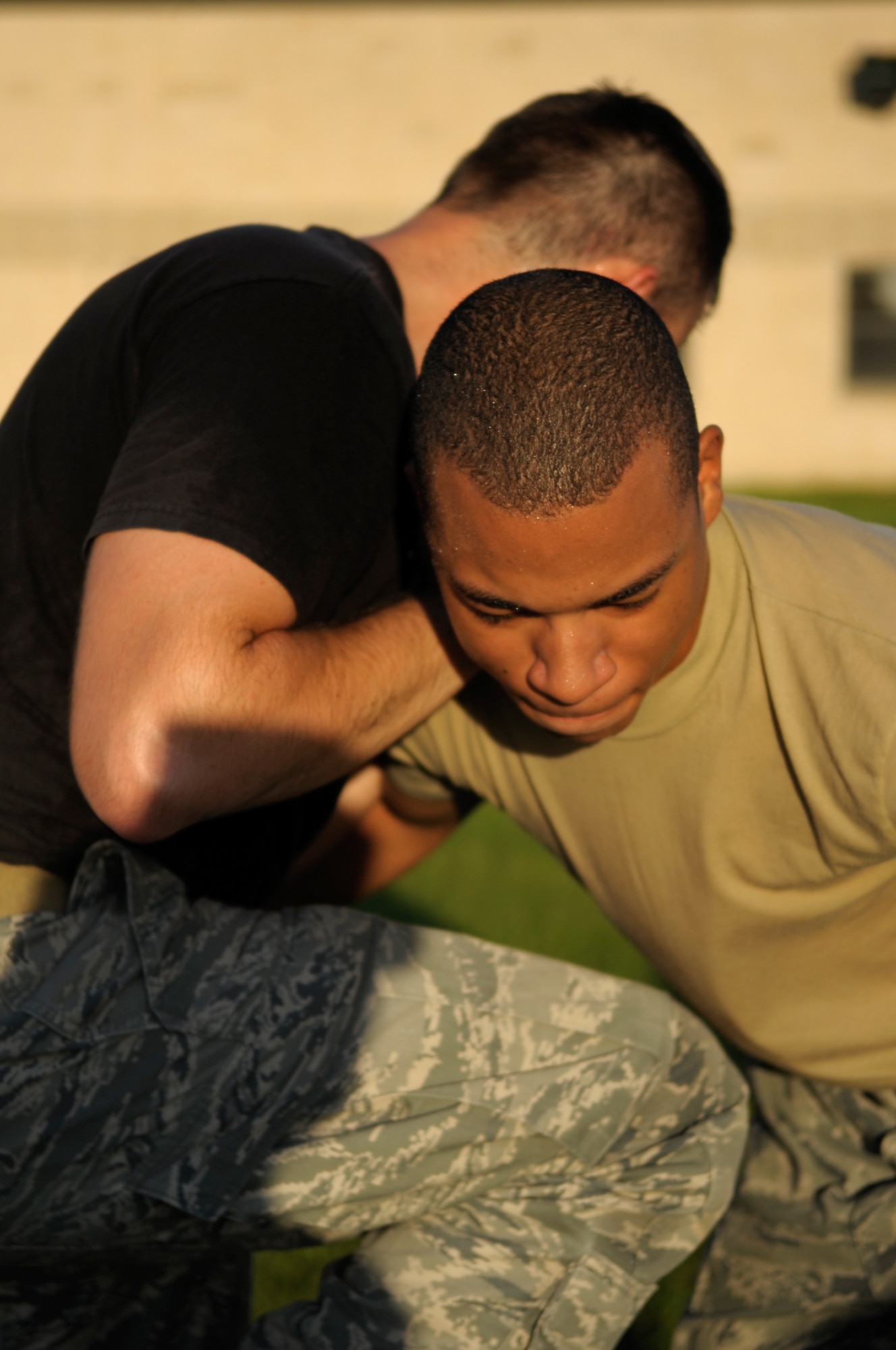 Senior Airman Thomas Meadows, 822nd Security Forces Squadron squad leader and Krav Maga instructor, teaches Airman 1st Class Carlos Fletcher, 822nd SFS fire team member, Krav Maga here Aug. 20. Krav Maga is a self defense system used by the 822nd SFS that uses realistic techniques and training scenarios. (U.S. Air Force photo/Staff Sgt. Andrea Thacker)