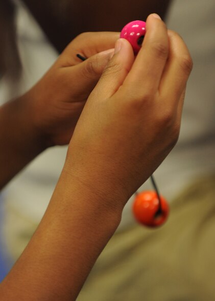 MOODY AIR FORCE BASE, Ga. -- Children from the Youth Center create bracelets with different size beads while participating in the first-ever Air Combat Command-sponsored Family Resiliency Training Workshop held here Aug. 27. The beads were used as a training tool to show the youth how to distinguish problems in their lives between big issues and small annoyances. (U.S. Air Force photo/ Airman 1st Class Benjamin Wiseman)