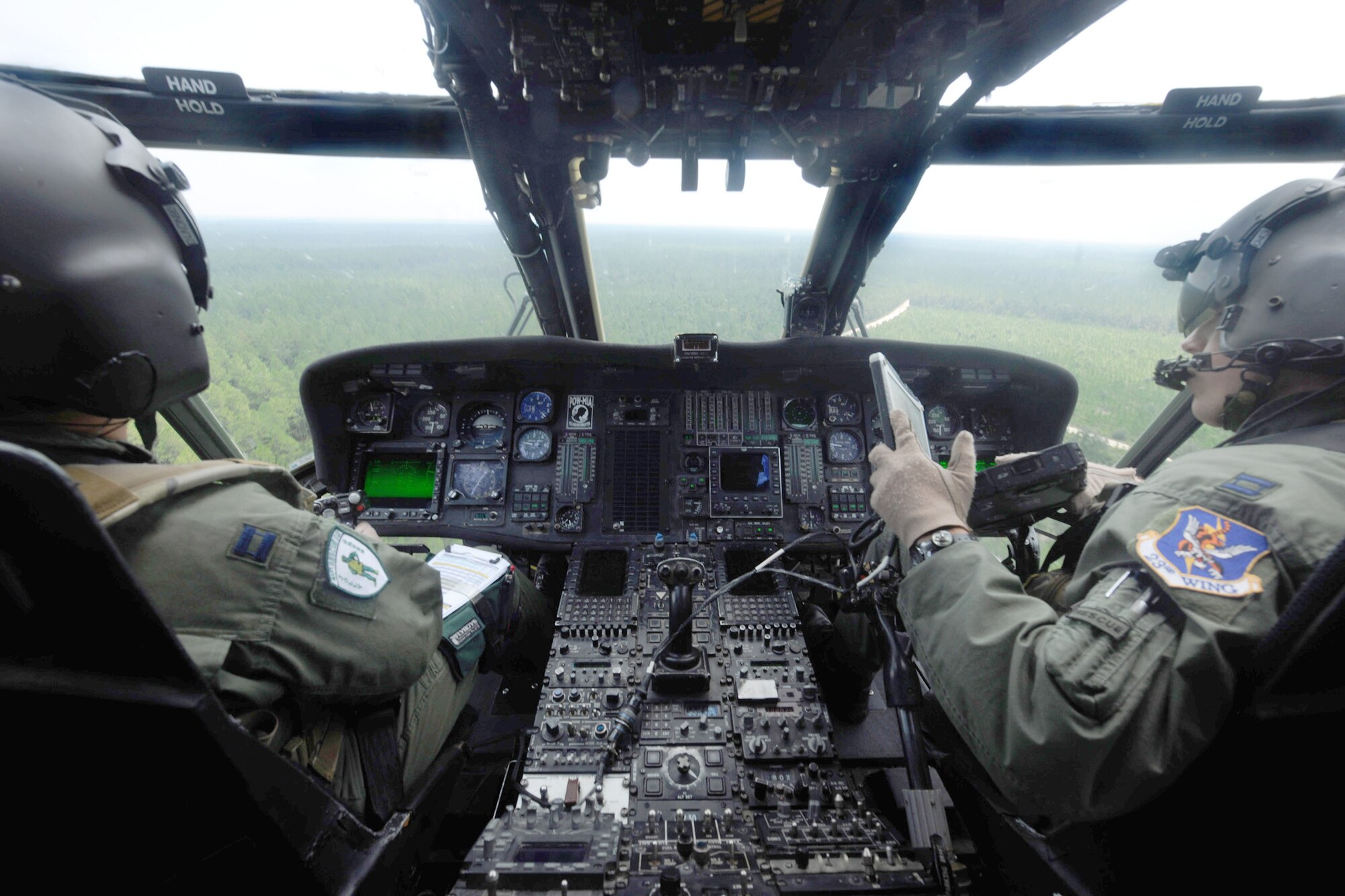 Two pilots fly an HH-60G Pave Hawk to begin munitions training Aug. 25, 2010, at the bombing and gunnery range at Moody Air Force Base, Ga. Each pilot took turns flying tactical maneuvers during the training. The pilots are from the 41st Rescue Squadron.  (U.S. Air Force photo/Airman 1st Class Benjamin Wiseman)