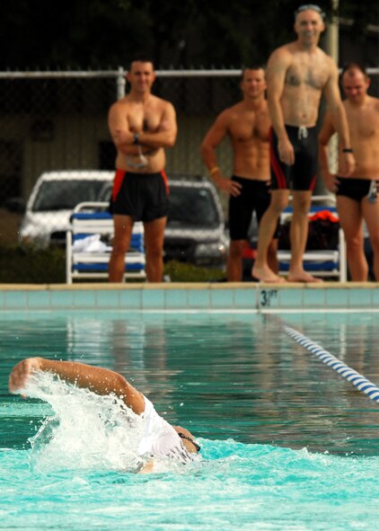 Members of the 53rd Wing team watches as their teammate finishes the last leg of the relay during the first-ever Water Olympics at Eglin Air Force Base, Fla., Aug. 27.  Teams from three different wings competed in three separate team-swim relays.  The 53rd team dominated the event winning all three relays with ease.  Teams from the 46th Test Wing and 96th Air Base Wing also competed.  (U.S. Air Force photo/Samuel King Jr.)