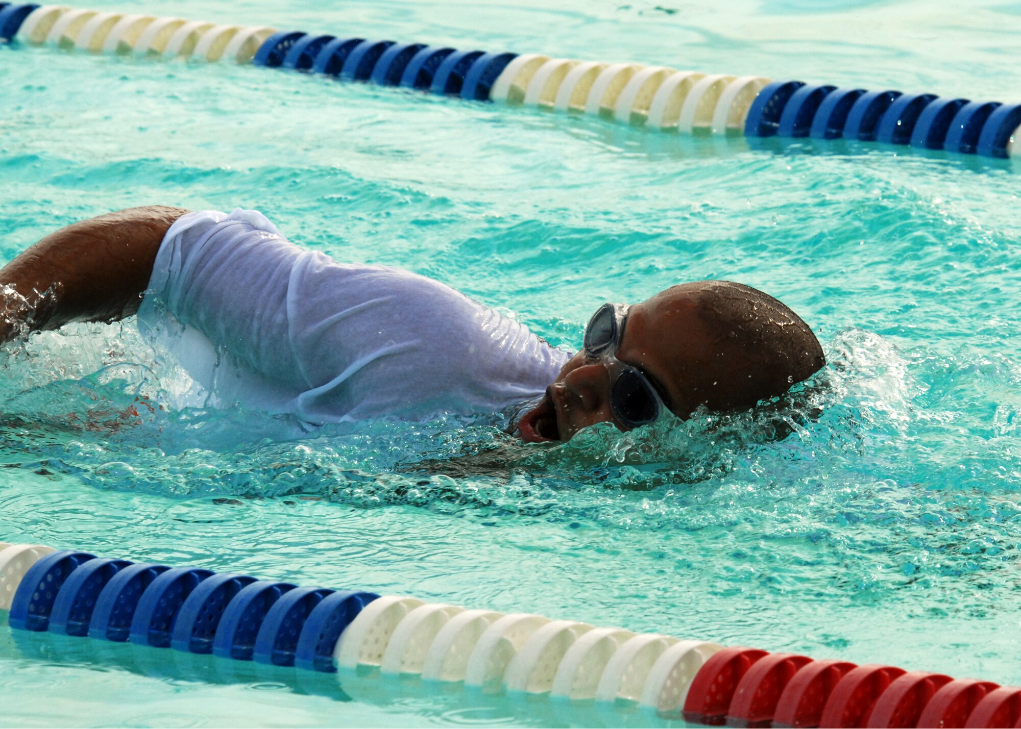 Jose Pvijlalta, 46th Test Wing, takes a breath during his relay lap at the first-ever Water Olympics at Eglin Air Force Base, Fla., Aug. 27.  Teams from three different wings competed in three separate team-swim relays.  The 53rd Wing team dominated the event winning all three relays with ease.  The 96th Force Support Squadron represented the 96th Air Base Wing.  (U.S. Air Force photo/Samuel King Jr.)