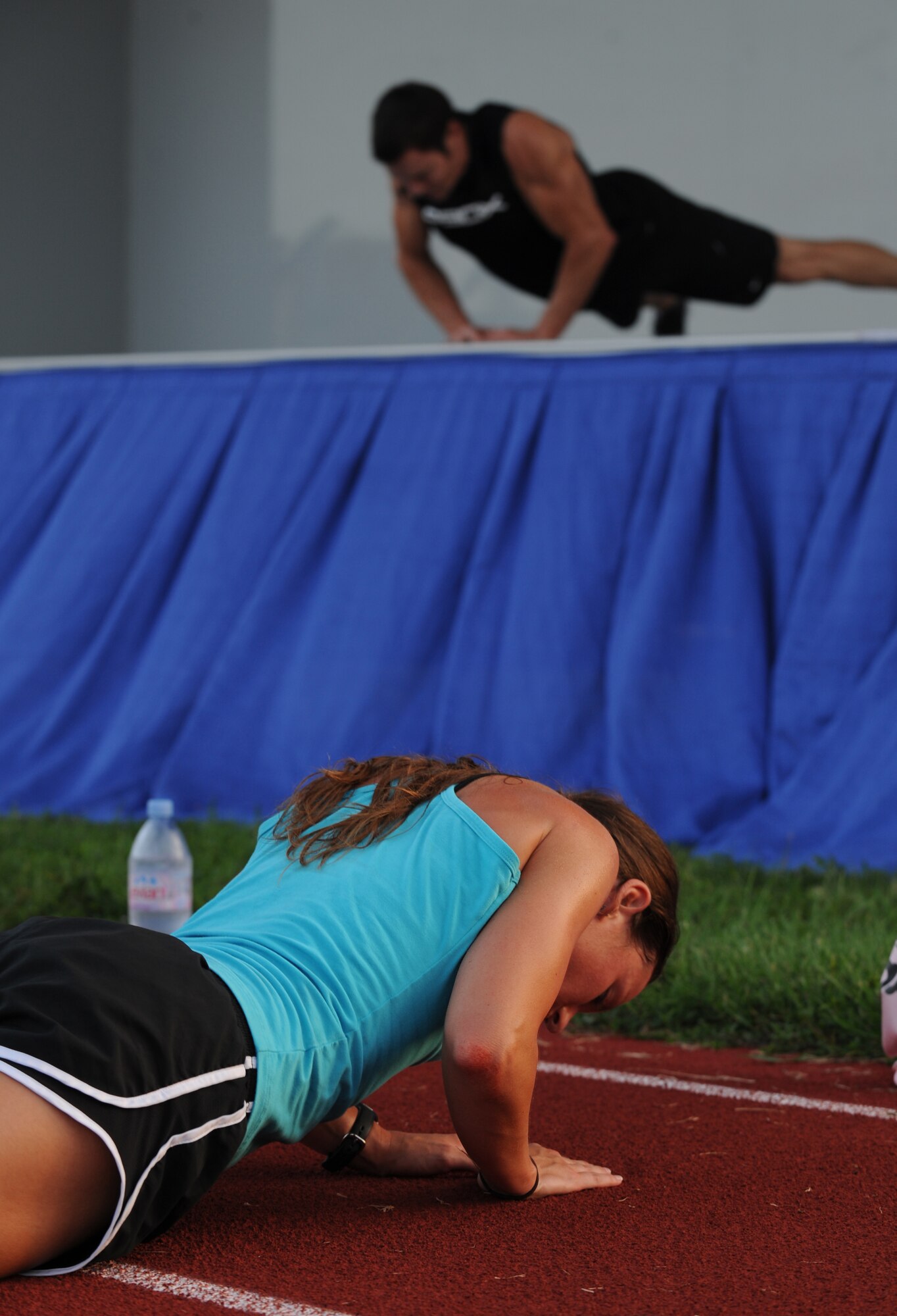 US Air Force Staff Sgt. Katie Merry, member of US Central Command,  focuses on instruction from Tony Horton, creator of workout program P90X, during intense workout at MacDill Air Force Base, Fla., Aug. 30, 2010.  Tony Horton conducted a free strength training workout for Team MacDill participants on the Short Fitness and Sports Center Ball Fields. (US Air Force photo by Tech Sgt. Tanika Belfield /Released)