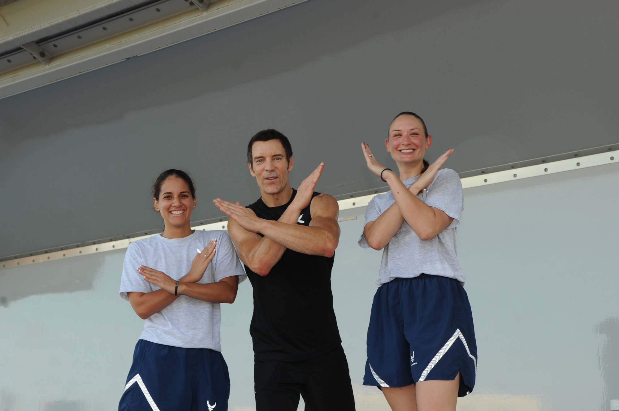 Senior Airmen Delma L. Laboy and Tammy M. Barco, members of 927th Air Refueling Wing Public Affairs, pose with special guest Tony Horton, creator of workout program P90X at MacDill Air Force Base, Fla., Aug. 30, 2010.  Tony Horton conducted a free strength training workout for Team MacDill participants on the Short Fitness and Sports Center Ball Fields. (US Air Force photo by Tech Sgt. Tanika Belfield /Released)