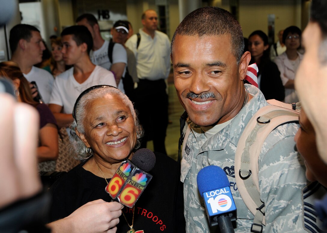 Senior Master Sgt  Luis Mateo, 48nd Fighter Wing Civil Engineer, along with his mother and wife, speak with media upon his return home from Iraq Aug 27. Thirteen Airmen from Homestead Air Reserve base arrived Aug 27 and seven returned Aug 28 The Airmen spent six months deployed to Kirkuk Air Base, Iraq working as road builders and light construction engineers. (U.S. Air Force photo by Senior Airman Lou Burton) 