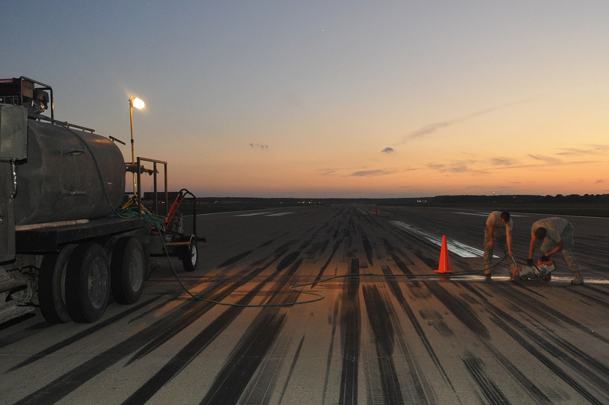 LANGLEY AIR FORCE BASE, Va – The 633d Civil Engineer Squadron pavement construction team, makes repairs to the runway Aug. 25. With the help of the 633d Civil Engineer Squadron and private contractors, the 1st Operations Support Squadron was able to overhaul the runway in just 10 days. (U.S. Air Force photo/Staff Sgt. Ashley Hawkins)(RELEASED)
