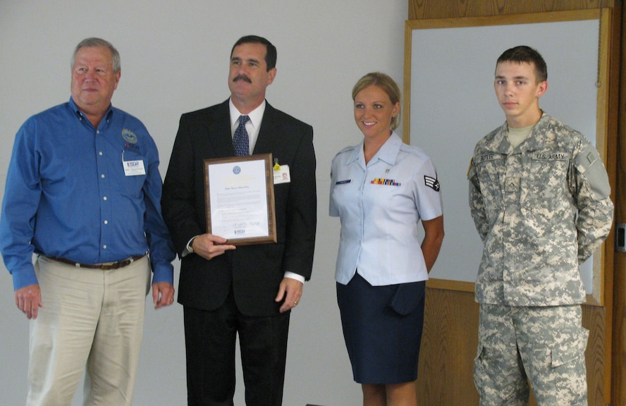 Senior Airman Jennifer Butler (second from right) stands proudly next to her employer, Will Mahone of Halifax Memorial Hospital, after he signs an Employer Support of Guard and Reserve Statement of Support. (Photo courtesy of NC ESGR)