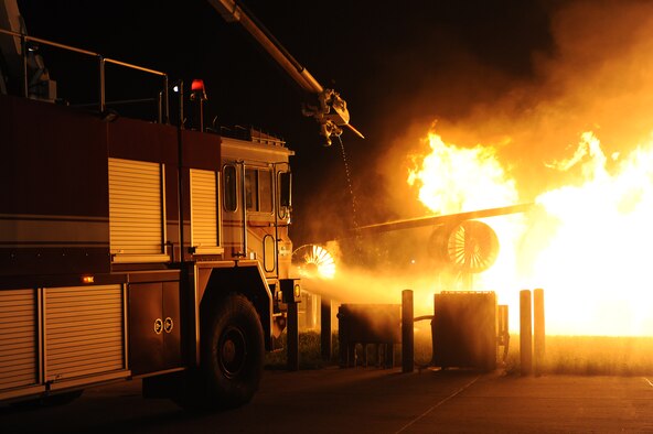 WHITEMAN AIR FORCE BASE, Mo. -A fire truck from the 509th Civil Engineer Squadron, extinguishes a simulated aircraft fire at the Whiteman fire training pit during an exercise, Aug. 23.  The fire department trains for aircraft emergencies and other base accidents on a daily basis. (U.S. Air Force photo by Senior Airman Carlin Leslie) 
