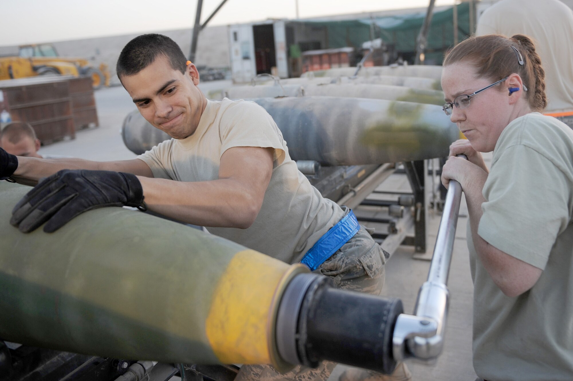 Staff Sgt. Misty Lowe tightens the super bolt while Airman 1st Class Anthony Anderson holds the bomb in place Aug. 23 at Kandahar Airfield, Afghanistan. Sergeant Lowe and Airman Anderson are munitions systems specialists with the 451st Expeditionary Maintenance Squadron Munitions Flight. (U.S. Air Force photo/Tech. Sgt. Chad Chisholm)