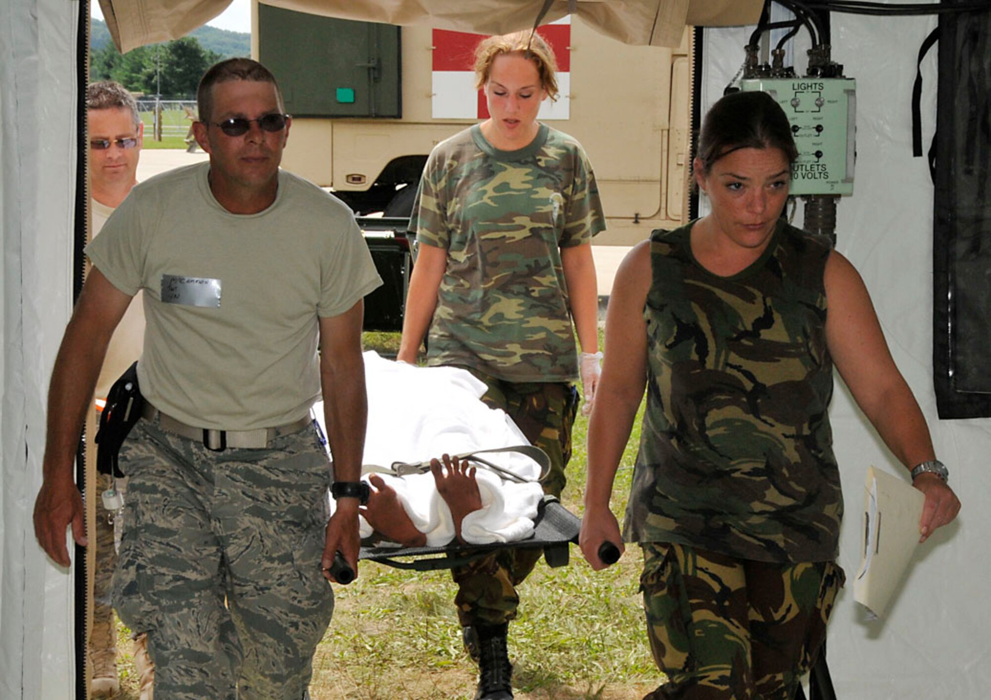 Tech. Sgt. McCammon (front left) and Tech. Sgt. Majors (back left) along with two Dutch Medics transport victim to staging area. Photo by Senior Master Sgt. John Chapman
