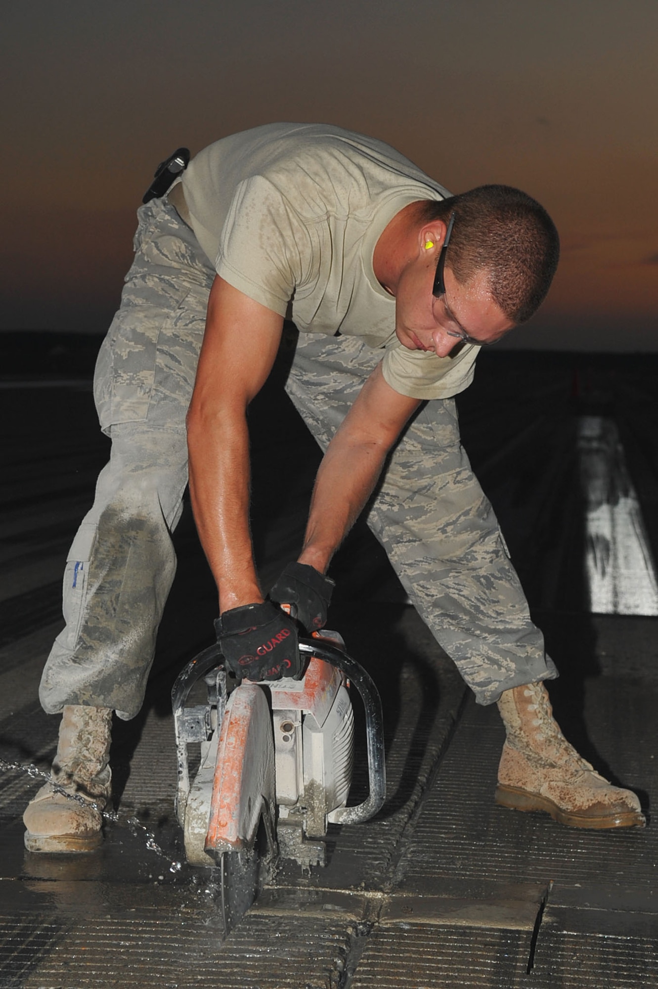 LANGLEY AIR FORCE BASE, Va --Senior Airman David Thalhamer, 633d Civil Engineer Squadron pavements and equipment apprentice, saws a portion of the runway Aug. 25. With the help of the 633d Civil Engineer Squadron and private contractors, the 1st Operations Support Squadron was able to overhaul the runway in just 10 days. (U.S. Air Force photo/Staff Sgt. Ashley Hawkins)(RELEASED)