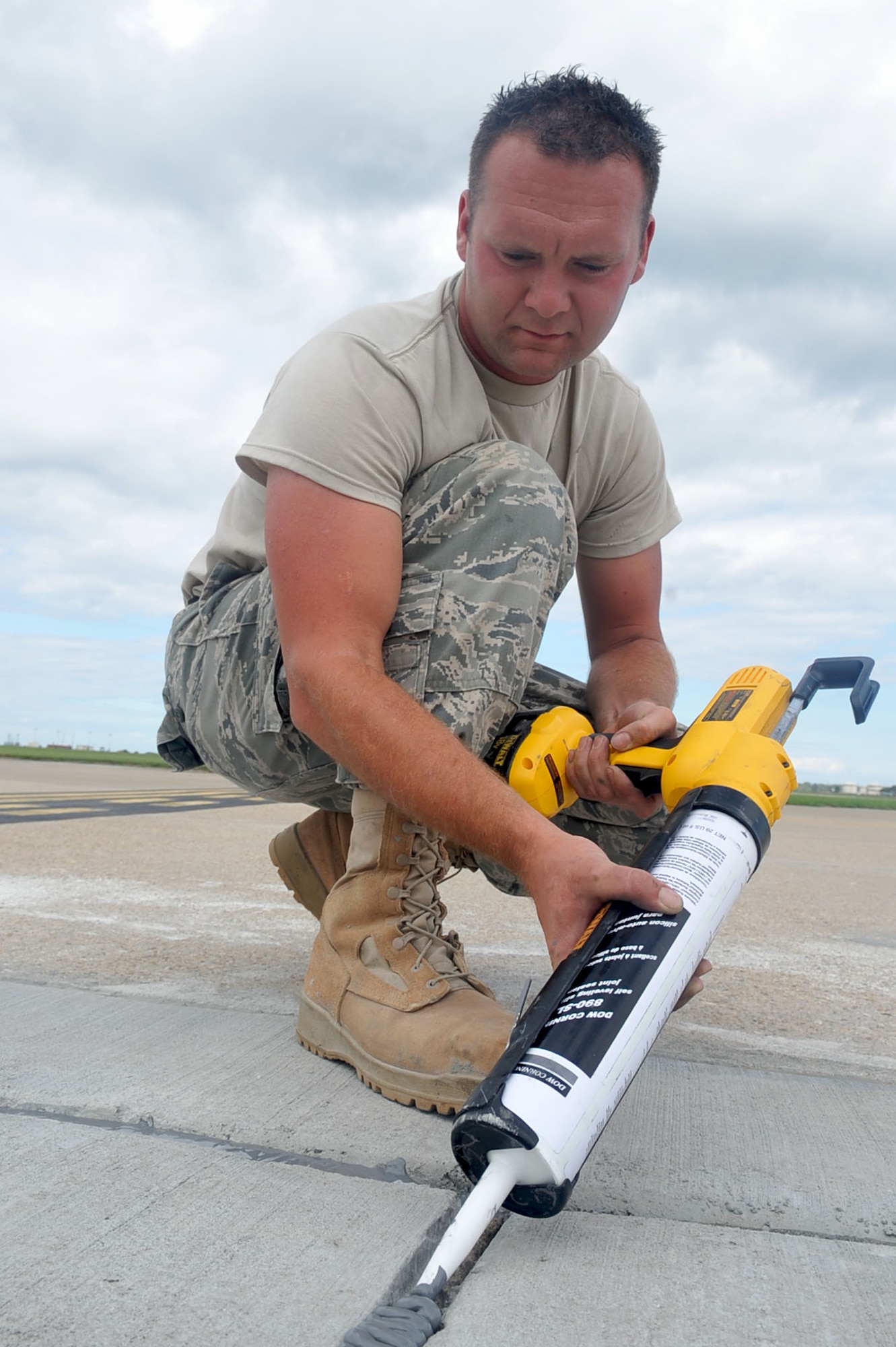 LANGLEY AIR FORCE BASE, Va -- Staff Sgt. Shannon Catherine, 633d Civil Engineer Squadron pavement construction, uses joint sealing to seal the cracks on a portion of the runway Aug. 25. Joint sealing is used to keep water from causing potential foreign object debris and runway accidents. (U.S. Air Force photo/Staff Sgt. Ashley Hawkins)(RELEASED)
