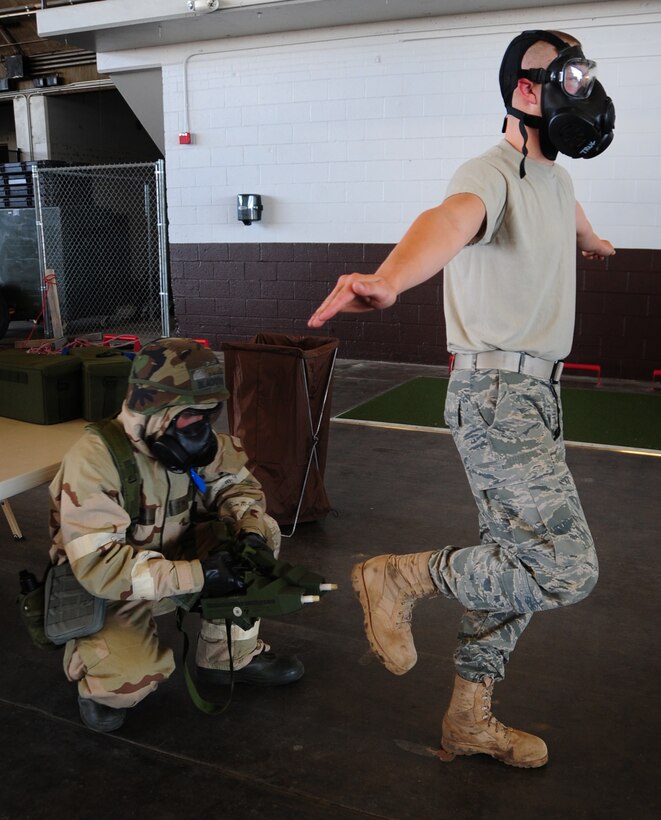 ELLSWORTH AIR FORCE BASE, S.D. -- (Left to right) Senior Airman Hugh
Blacketor, 28th Civil Engineer Squadron heating, ventilation and
air-conditioning journeyman, uses two hand-held chemical detectors to check for simulated contamination on Airman 1st Class  Michael Mays, 28 CES structural apprentice, during a phase II operational readiness exercise, Aug. 24.  Airmen are tested during the exercise on a multitude of
situations, such as, chemical attacks. (U.S. Air Force photo/Airman 1st
Class Anthony Sanchelli)
