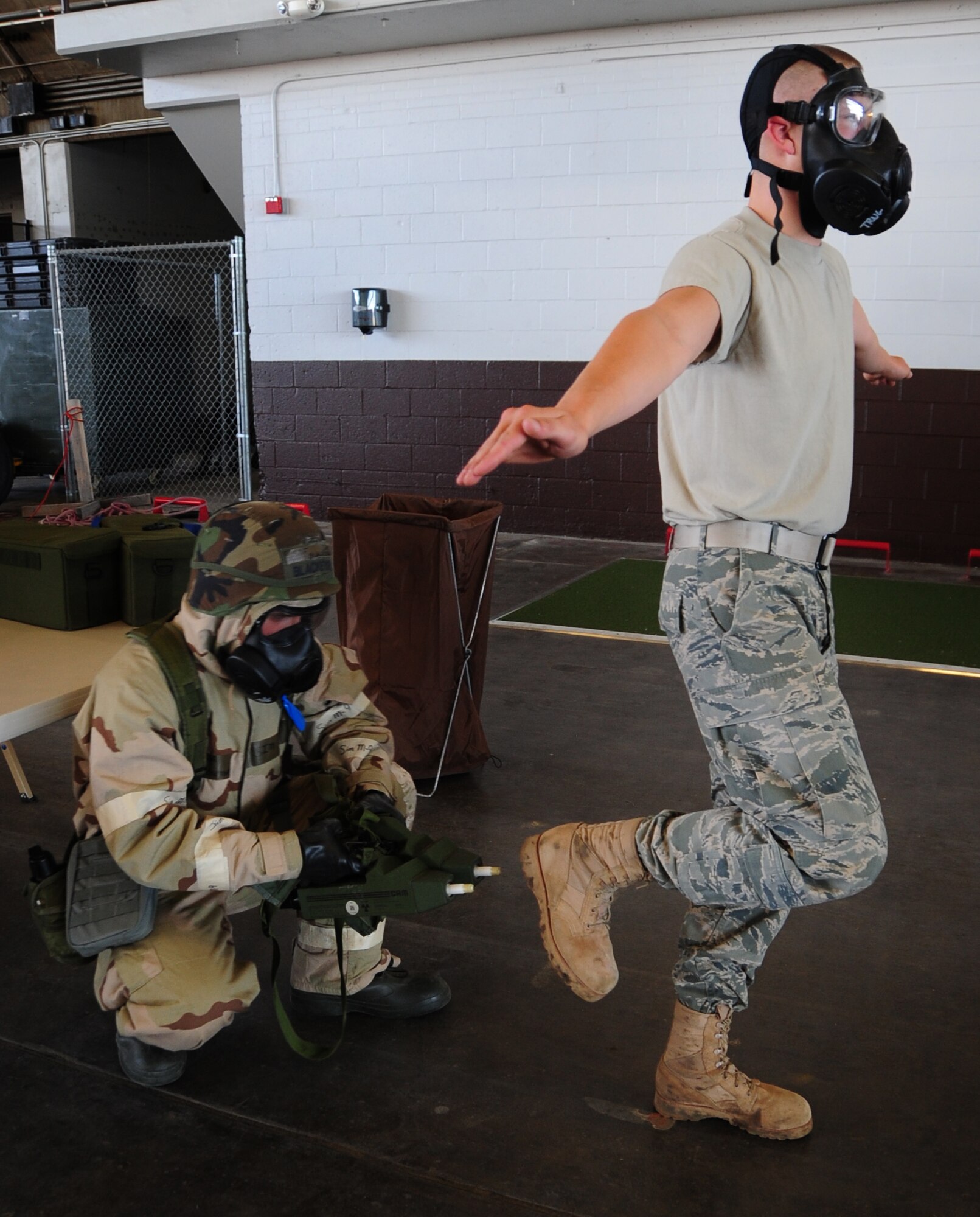 ELLSWORTH AIR FORCE BASE, S.D. -- (Left to right) Senior Airman Hugh
Blacketor, 28th Civil Engineer Squadron heating, ventilation and
air-conditioning journeyman, uses two hand-held chemical detectors to check for simulated contamination on Airman 1st Class  Michael Mays, 28 CES structural apprentice, during a phase II operational readiness exercise, Aug. 24.  Airmen are tested during the exercise on a multitude of
situations, such as, chemical attacks. (U.S. Air Force photo/Airman 1st
Class Anthony Sanchelli)
