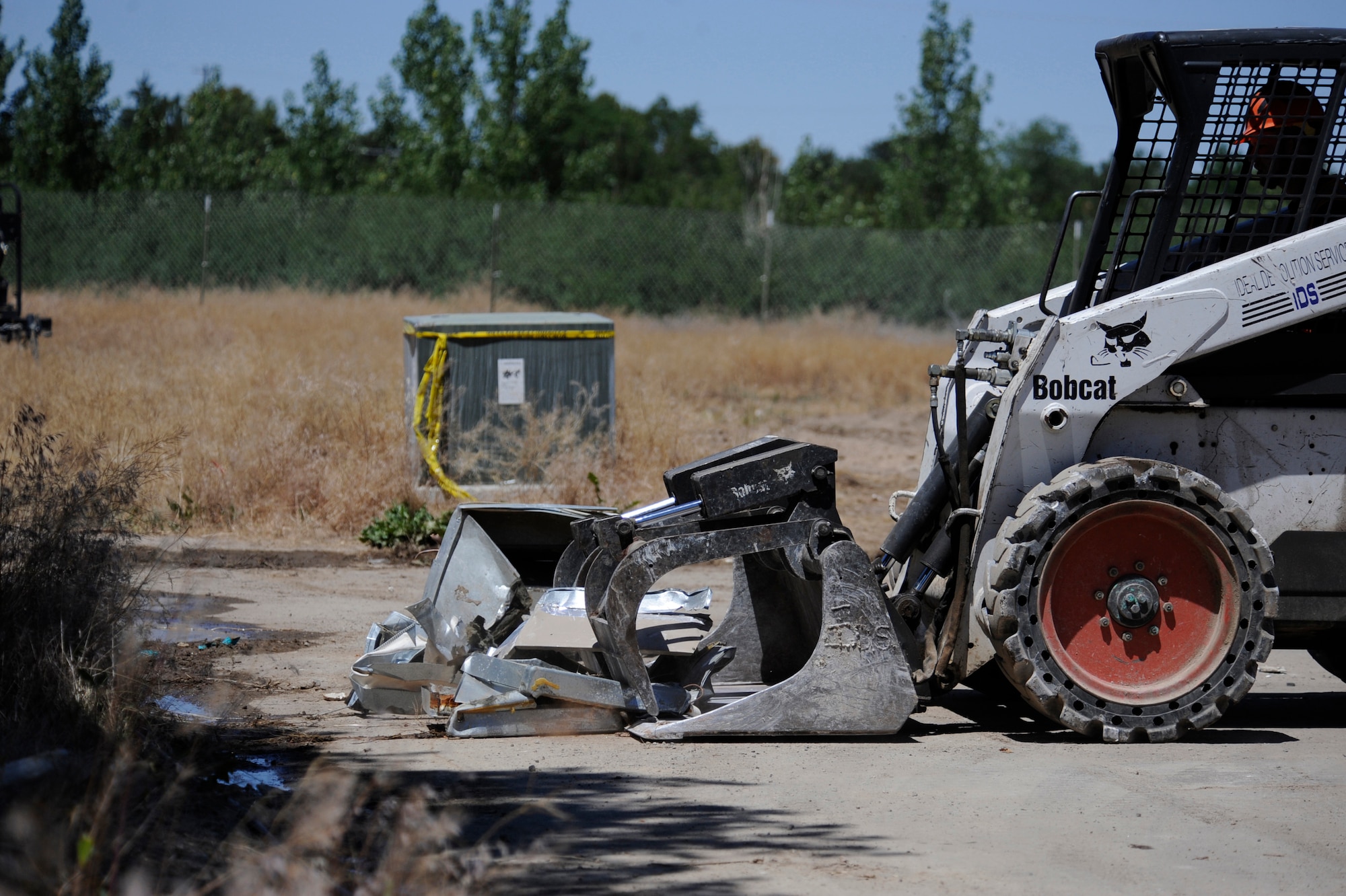 MOUNTAIN HOME AIR FORCE BASE, Idaho – Contractors work to clean up scrap metal from the 1970’s era Dunes Housing here. The $1.5 million project to tear down the housing has been ongoing since mid June and is expected to be completed in December. The deconstruction project can divert 80 percent to 90 percent of a structure's total weight from the landfill into reuse or recycling. (U.S. Air Force photo by Senior Airman Renishia Richardson)