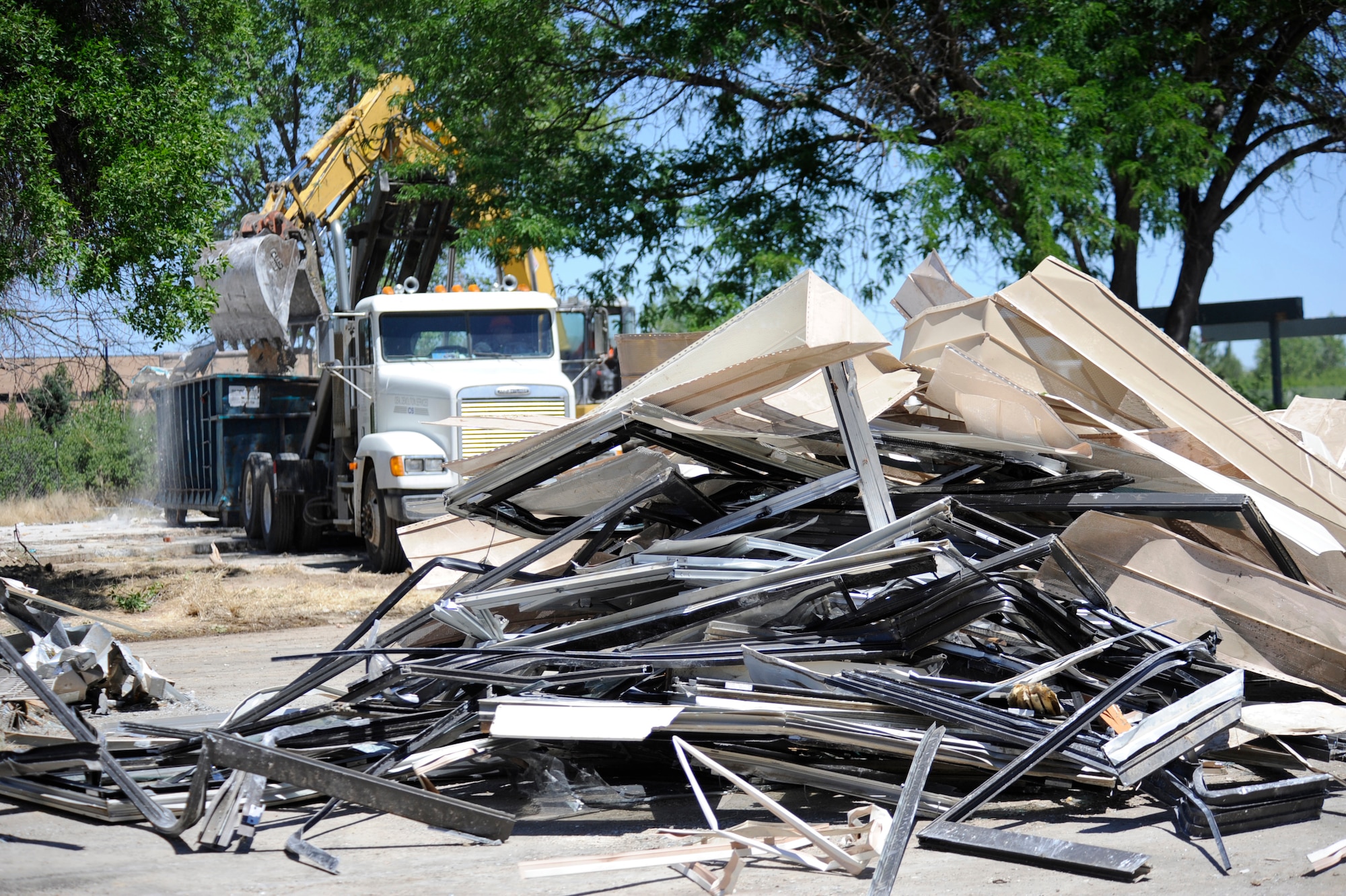 MOUNTAIN HOME AIR FORCE BASE, Idaho – Contractors work to clean up scrap metal from the 1970’s era Dunes Housing here. The $1.5 million project to tear down the housing has been ongoing since mid June and is expected to be completed in December. The deconstruction project can divert 80 percent to 90 percent of a structure's total weight from the landfill into reuse or recycling. (U.S. Air Force photo by Senior Airman Renishia Richardson)