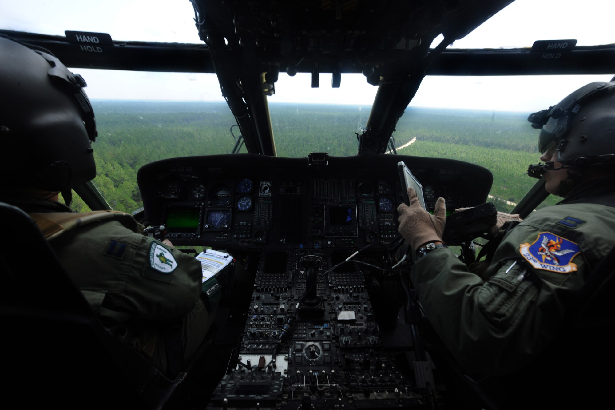 MOODY AIR FORCE BASE, Ga. -- Two pilots from the 41st Rescue Squadron fly an HH-60G Pave Hawk out to the Grand Bay Bombing and Gunnery Range to begin munitions training here Aug. 25. Each pilot took turns flying tactical maneuvers during the training. (U.S. Air Force photo/Airman 1st Class Benjamin Wiseman)
