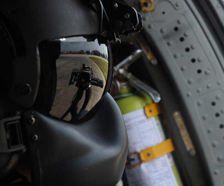 MOODY AIR FORCE BASE, Ga. -- Senior Airman David Mitchell, 41st Rescue Squadron flight engineer, glances out of an HH-60G Pave Hawk as it takes off for training here Aug. 25. The HH-60G took off with a four man crew consisting of an aerial gunner, flight engineer and two pilots. (U.S. Air Force photo/Airman 1st Class Benjamin Wiseman)
