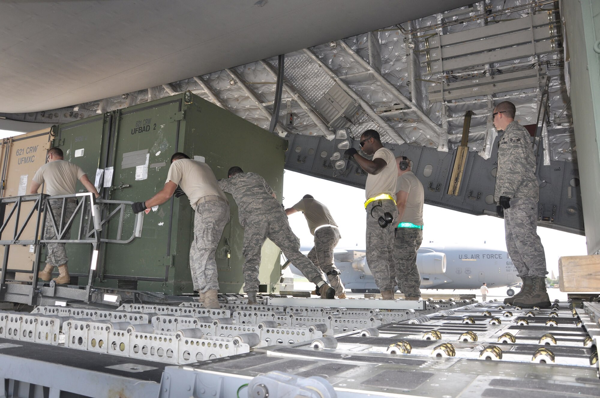 Airmen unload 621st Contingency Response Element equipment and supplies from a C-17 Globemaster III cargo aircraft Aug. 28, 2010, at Pakistan Air Force Base Chaklala, Pakistan. Approximately 40 Airmen from the 621st Contingency Response Wing arrived in Pakistan Aug. 28, 2010, to support Pakistan's flood relief operations. The Airmen will work in partnership with Pakistan government and military officials to support humanitarian airlift operations delivering relief supplies to required locations throughout Pakistan. (U.S. Air Force photo/Lt. Col. Patrick Ryder)
