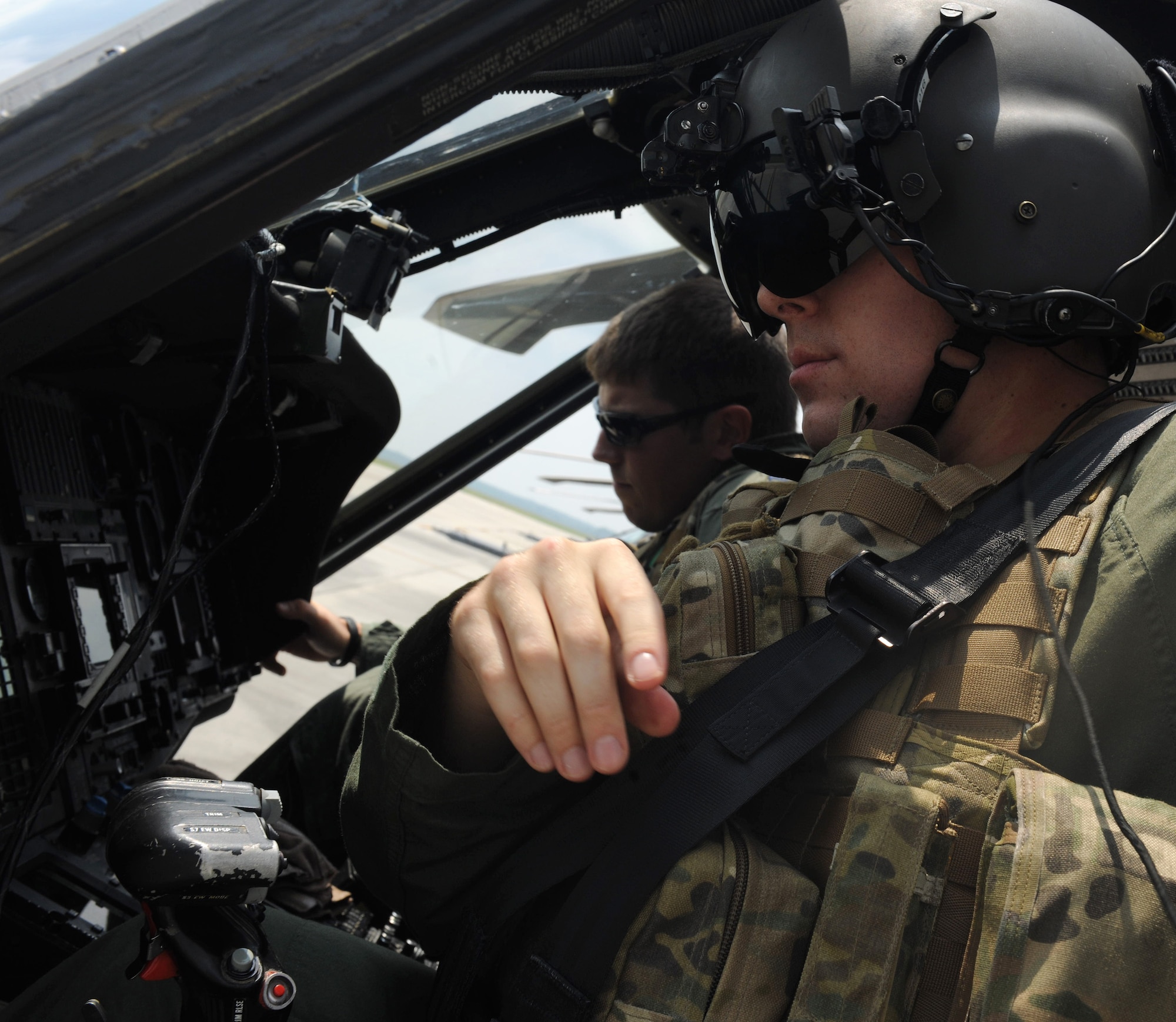 MOODY AIR FORCE BASE, Ga. -- Capt. Kyle Waite, 41st Rescue Squadron HH-60G Pave Hawk pilot, straps himself into the cockpit here Aug. 25. Captain Waite and his crew flew to several different landing zones and also practiced artillery fire during their flight. (U.S. Air Force photo/ irman 1st Class Benjamin Wiseman)
