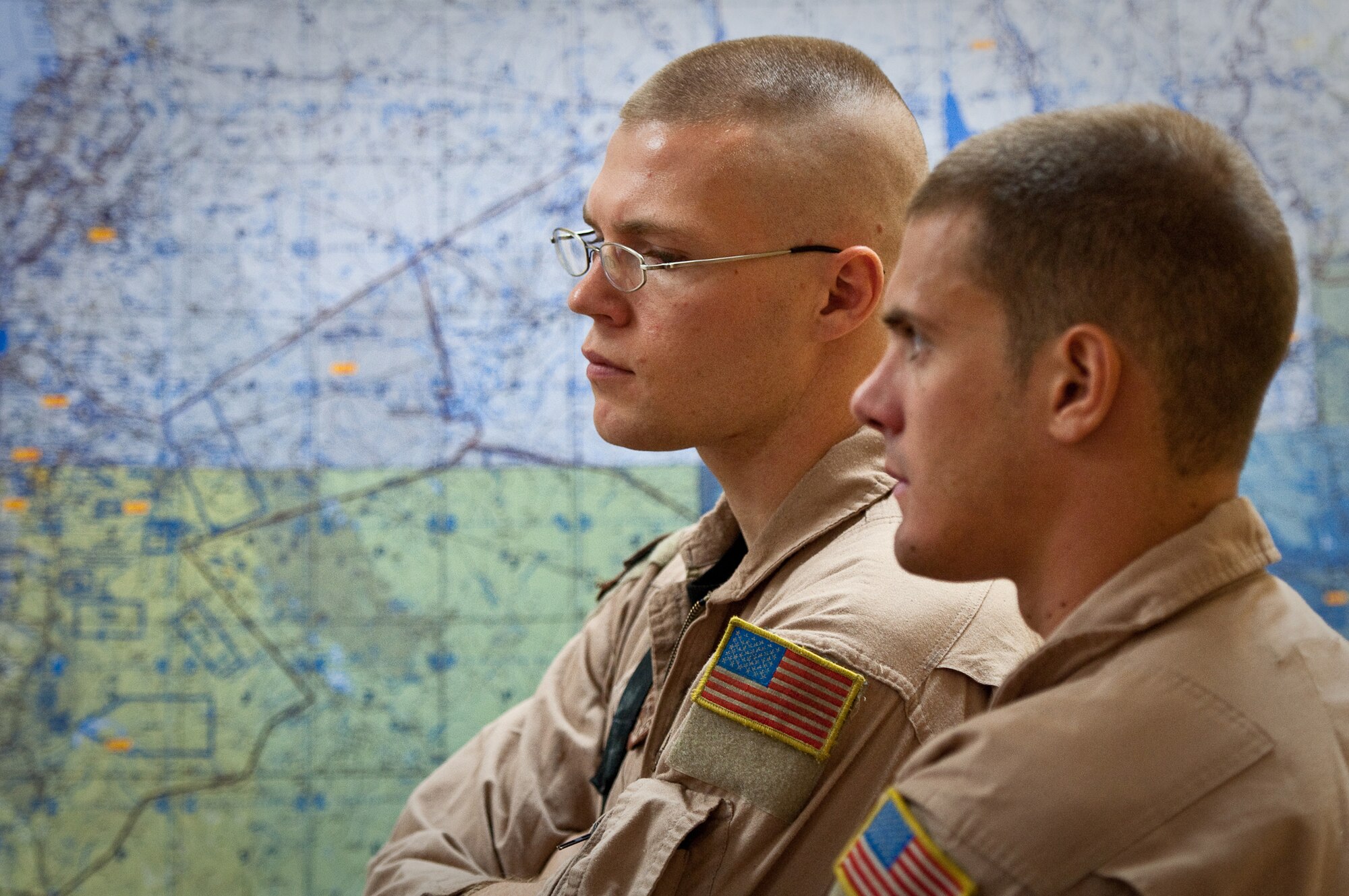 SOUTHWEST ASIA - Staff Sgt. Steve Otto (left) and Airman 1st Class Joseph Mongarella, loadmasters with the 737th Expeditionary Airlift Squadron, listen to a pre-flight intelligence briefing at an undisclosed airbase here Aug. 30, 2010, as Airmen from the 386th Air Expeditionary Wing prepare to fly relief supplies into Pakistan. Record-setting monsoons have killed more than 1,600 Pakistanis and left over 2 million homeless, government officials said. The Airmen will be based at Bagram Air Field, Afghanistan, for the relief mission, which has already delievered hundereds of thousands of pounds of food, water and medicine to Pakistan. (U.S. Air Force photo by Maj. Dale Greer/Released)