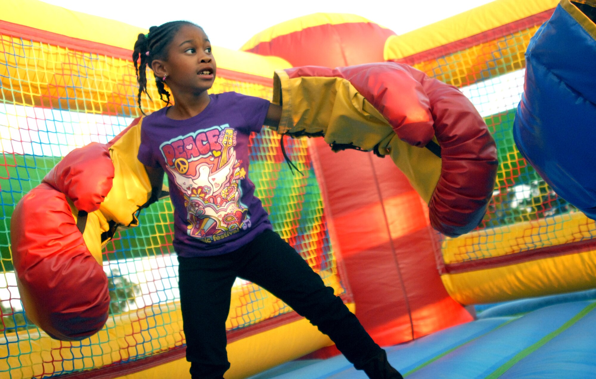 Dejah Williams, 7, gets ready to knock out her competitor at one of the games during the Year of the Air Force Family finale celebration Aug. 27. More than 100 families gathered on the field by the Event Center for free food, games and a movie on the lawn.(U.S. Air Force photo/Connie Hempel)