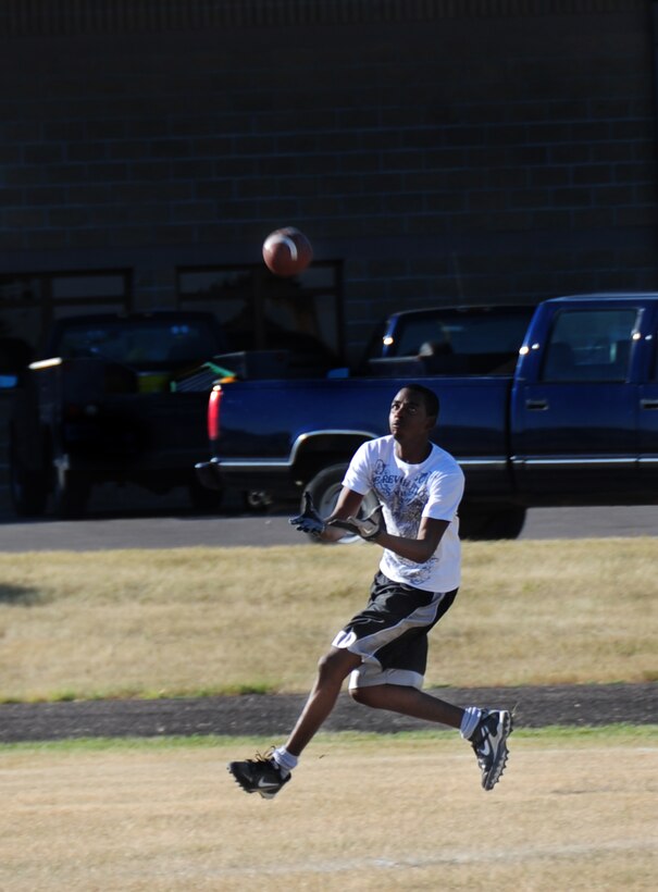 ELLSWORTH AIR FORCE BASE, S.D. -- Airman 1st Class Steve Pearson, Air Force Financial Services Center travel technician, runs out to catch a pass during a football practice, Aug. 26.  It's important to wear all the proper protective equipment and stretch before sports related exercises to avoid injuries. (U.S. Air Force photo/Airman 1st Class Anthony Sanchelli)