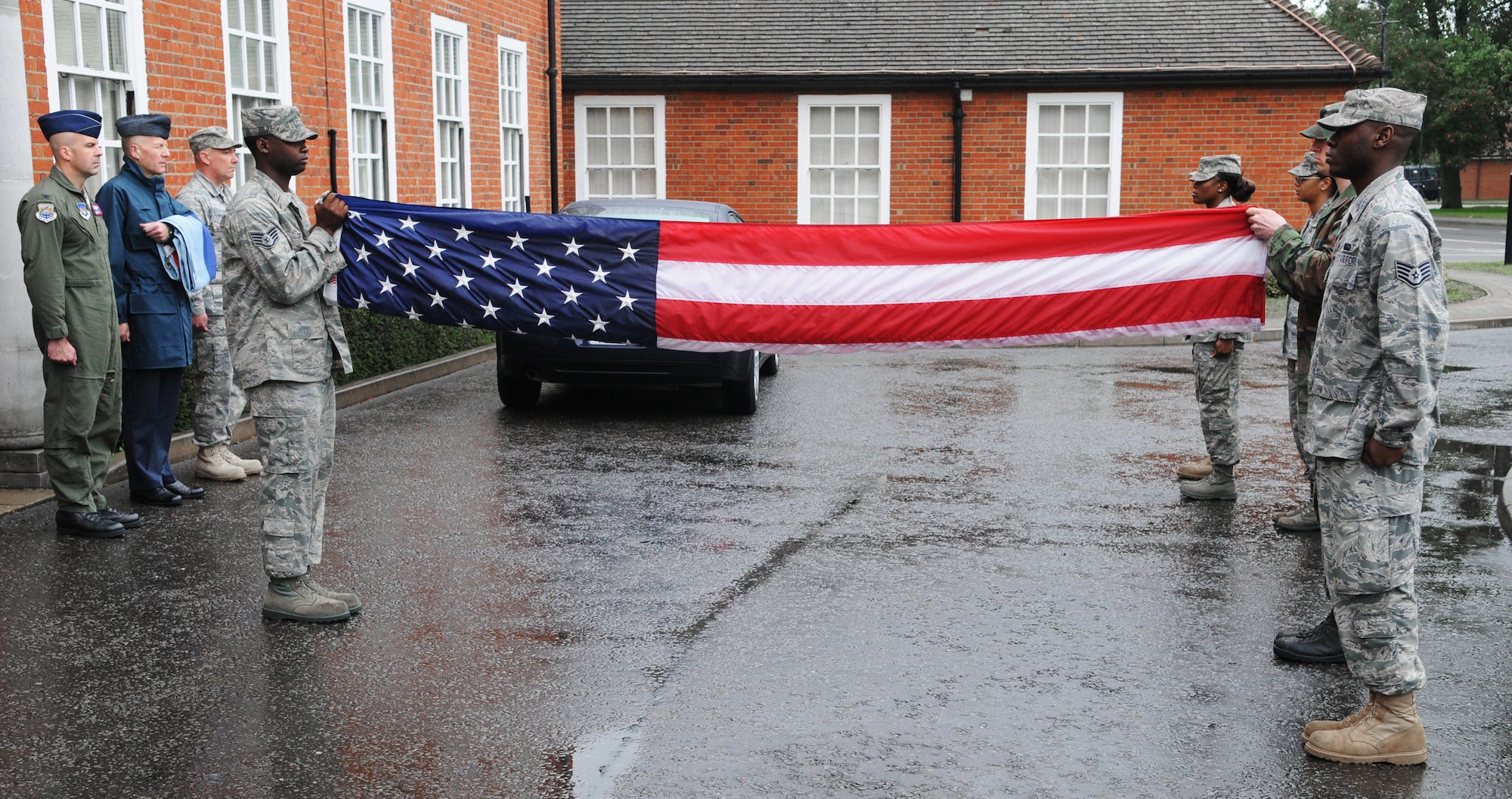 RAF MILDENHALL, England -- A flag security detail fold the colors during Retreat outside 100th Air Refueling Wing Headquarters Aug. 26. After the flag is secure, it is presented to the wing commander as a way of paying respect to the flag. (U.S. Air Force photo/Staff Sgt. Thomas Trower) 