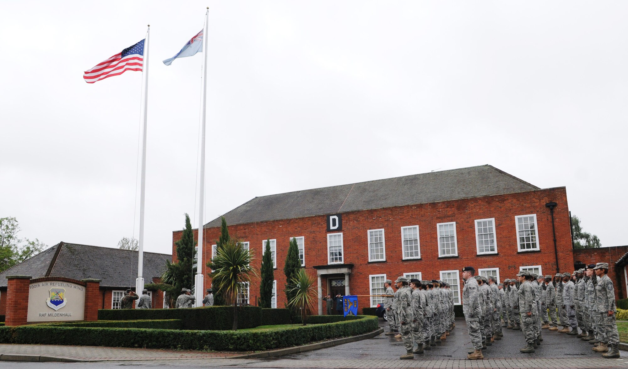RAF MILDENHALL, England -- Airmen from the 100th Mission Support Group stand in formation for Retreat outside the 100th Air Refueling Wing Headquarters Aug. 26. Retreat signals the end of the duty day while also paying respect to the flag. (U.S. Air Force photo/Staff Sgt. Thomas Trower) 