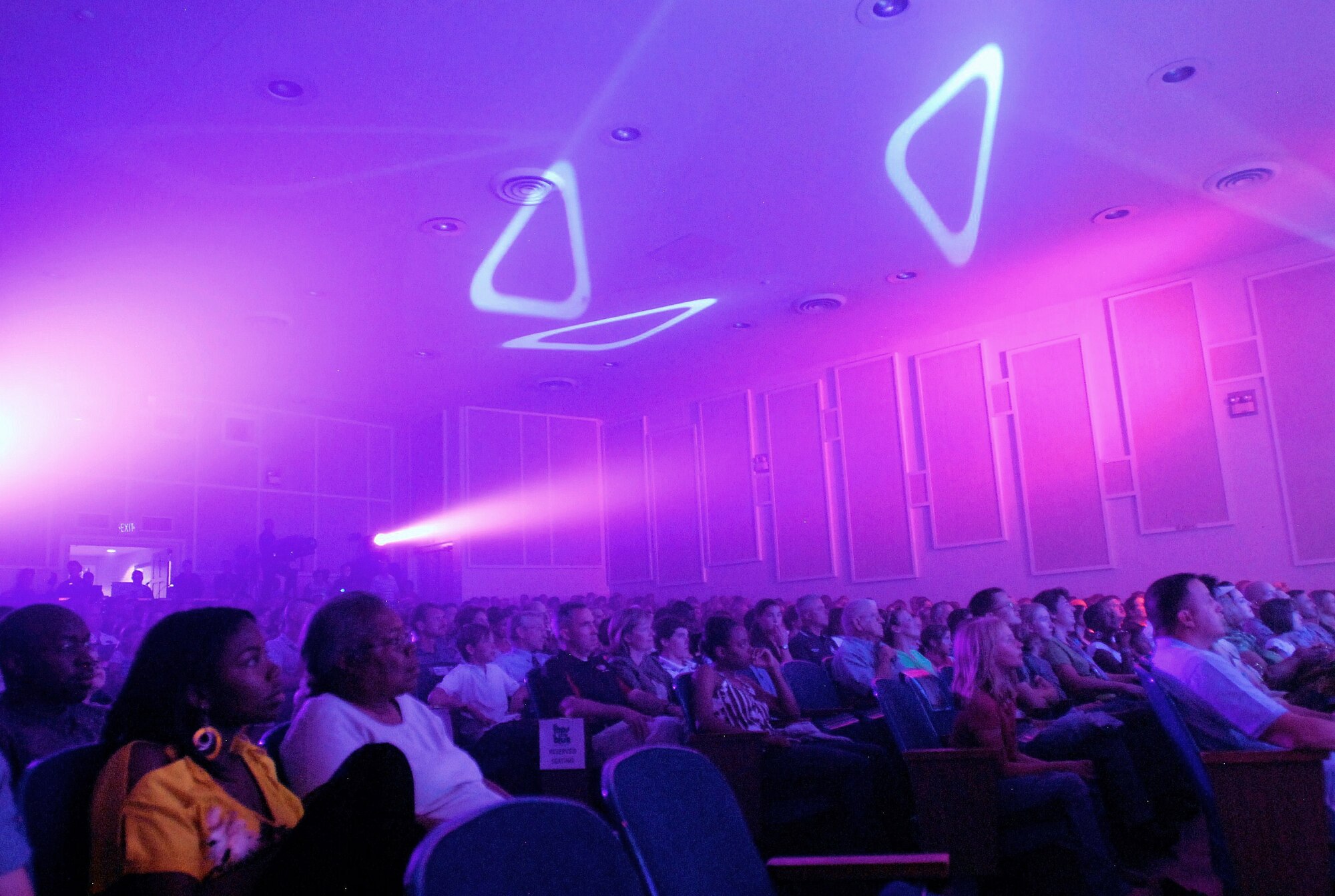 Audience members watch as Tops in Blue performs at Peterson Air Force Base auditorium Aug. 20. In 1981, Tops in Blue and more than 250 volunteers from McGuire Air Force Base, N.J., produced the Garden State Bowl half-time show. (U.S. Air Force photo/Airman 1st Class Jessica Hines)