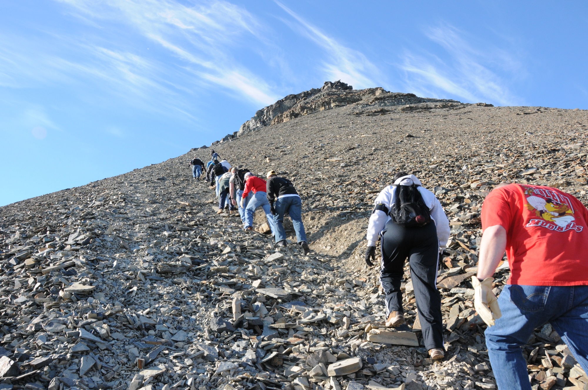 Members of the 821st Support Squadron at Thule Air Base, Greenland, hiked up the 724-foot high Thule landmark, Mount Dundas, Aug. 23 following a commander’s call. The Ravens rallied at the foot of the mountain to make the climb, which took about one hour because in the final 50-feet of the climb Airmen had to use a fixed rope and go up single file, one at a time. The climb was the first of many planned team-building events for the squadron. (U.S. Air Force photo/Master Sgt. Petra Wright)