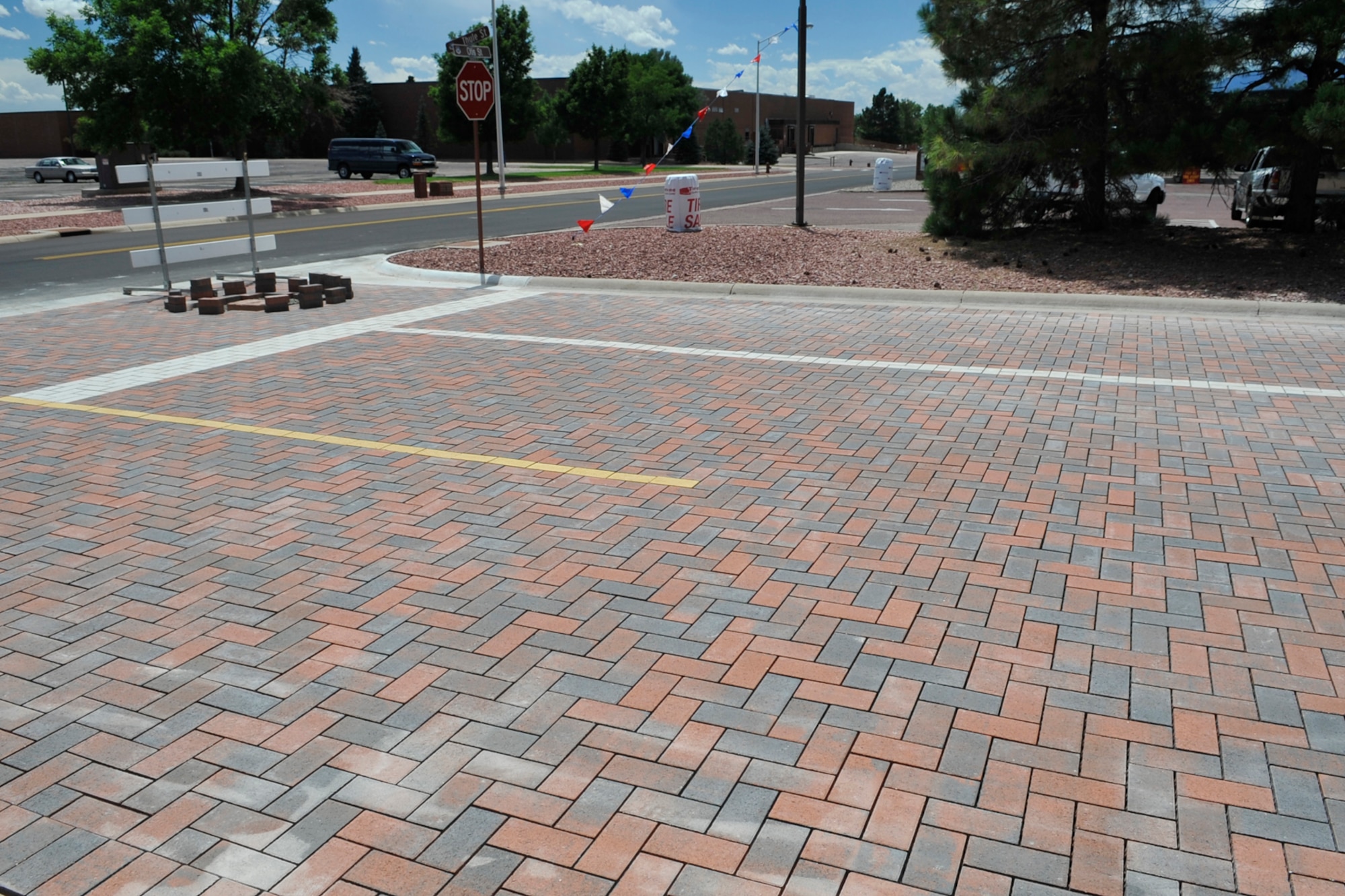 Construction crews are expected to complete a road project on Thule Street, next to McDonald’s Restaurant, on Peterson Air Force Base by the end of August. Permeable pavers allow storm water to seep through the spaces between bricks into a subsurface detention area thereby reducing storm water runoff, which is part of Environmental Protection Agency and Department of Defense mandates for all federal development and redevelopment projects. (U.S. Air Force photo/Rob Bussard)