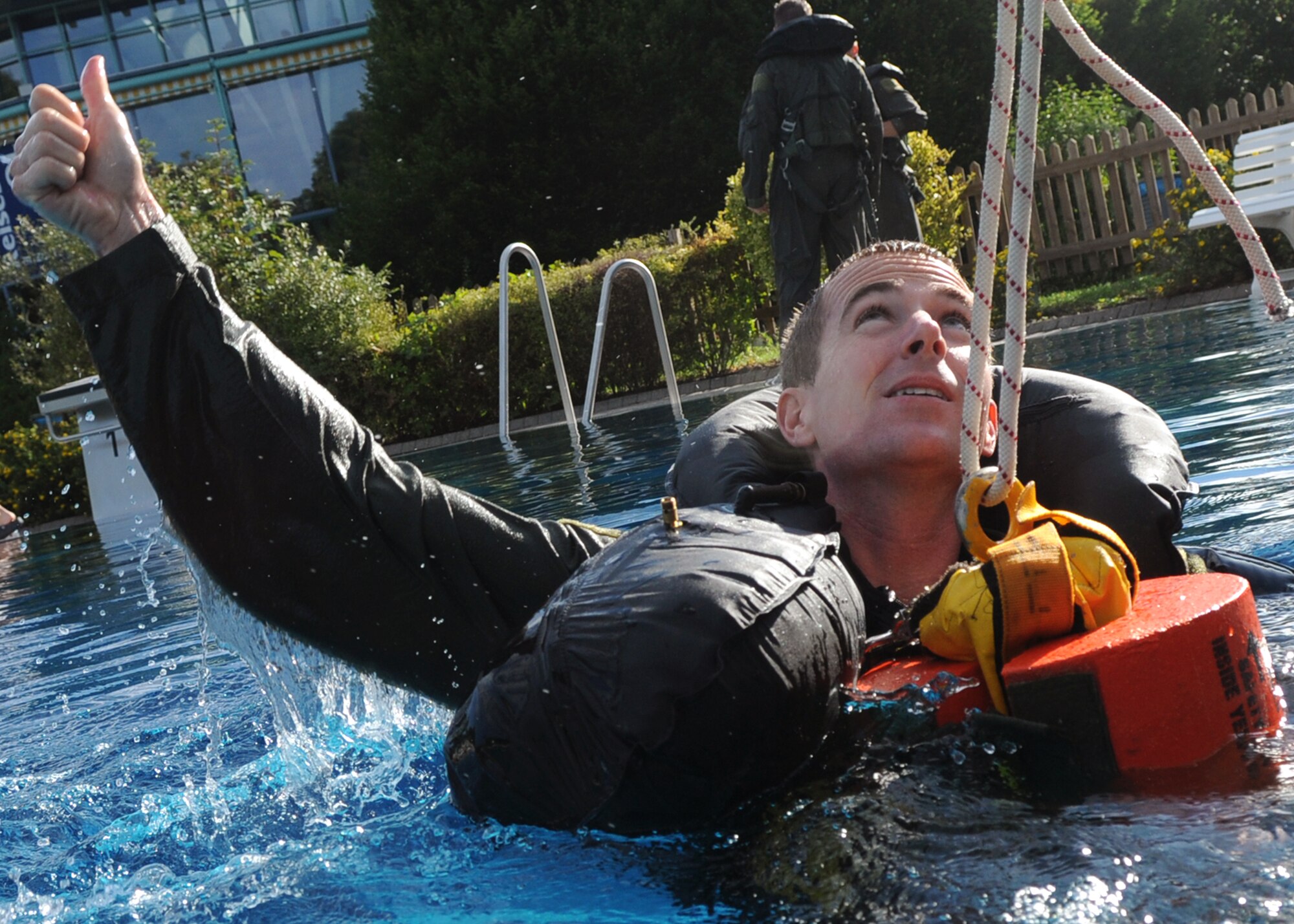 SPANGDAHLEM AIR BASE, Germany -- Capt. Mark Hickie, 480th Fighter Squadron F-16 Fighting Falcon pilot, signals to simulated rescue crews that he is ready to be lifted from the water during water survival training  Aug. 20.  Water survival is one part of recurring survival, evasion, resistance and escape training and is tailored to conditions pilots from Spangdahlem might face flying over the North Atlantic Ocean.  (U.S. Air Force photo/Staff Sgt. Logan Tuttle)  