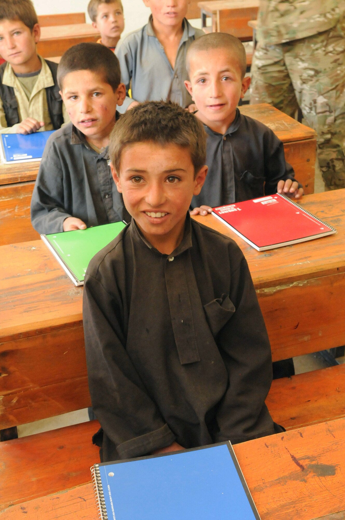 Students who attend the Kur Petab boys middle school in Khenj District receive a new notebook delivered by members of Provincial Reconstruction Team Panjshir?s civil affairs team.  The notebooks were donated by numerous friends and family members of Team Panjshir.  (U.S. Air Force photo by: Tech. Sgt. Sean Mateo White PRT Panjshir photographer)   