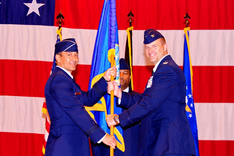 U.S. Air Force Col. Kip B. Turain accepts the 521st Air Mobility Operations Wing command guidon from Brig. Gen. Michael Kim, 21st Expeditionary Mobility Task Force commander, Ramstein Air Base, Germany, Aug. 30, 2010. (U.S. Air Force photo by Airman 1st Class Brea Miller)