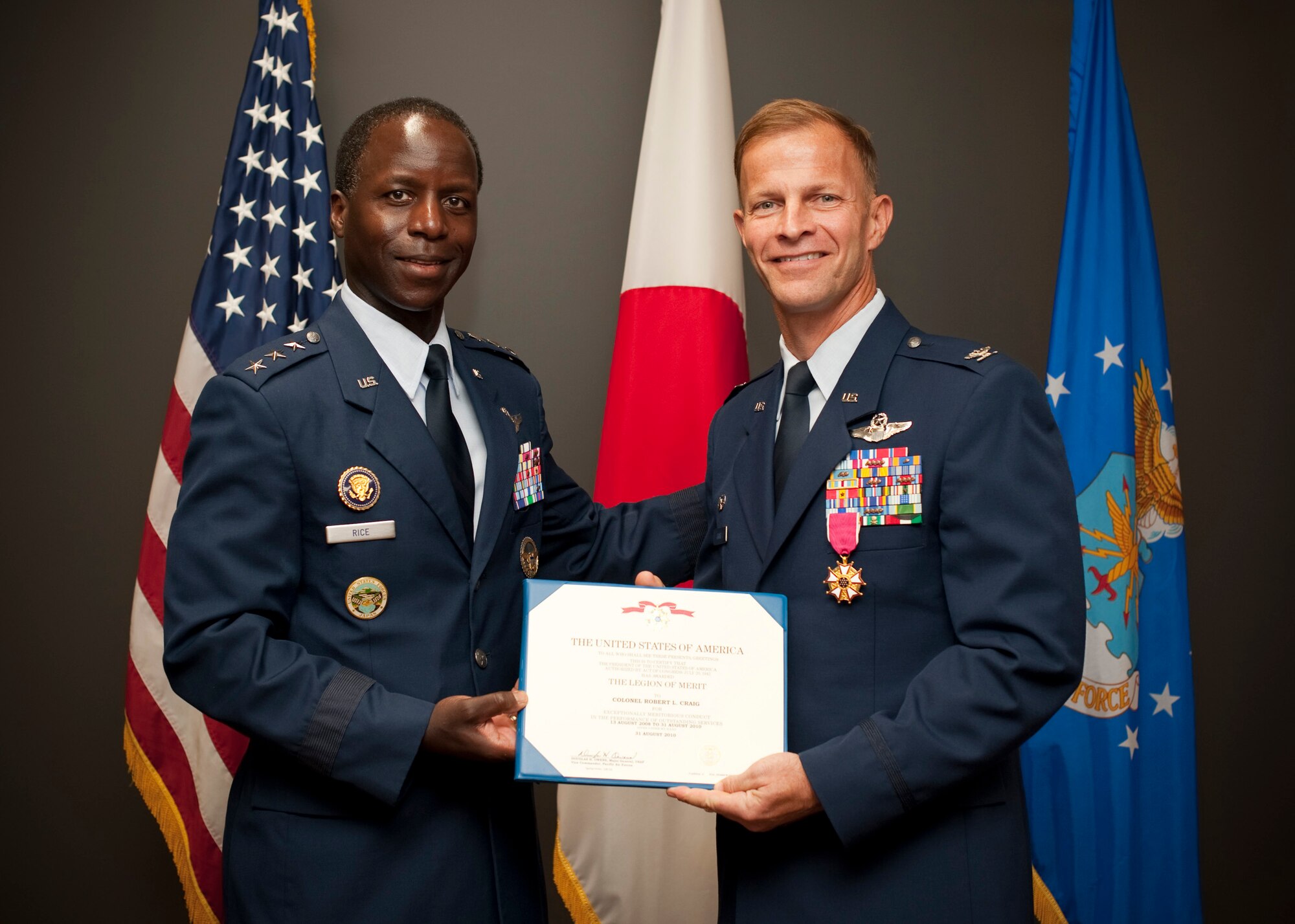 MISAWA AIR BASE, Japan -- Lt. Gen. Edward A. Rice Jr., U.S. Forces Japan commander and 5th Air Force commander, presents Col. RC Craig, 35th Fighter Wing commander, with a legion of merit here Aug. 30. Colonel Craig earned the award for service as the wing vice commander during the majority of his tenure, and as wing commander during his final weeks at Misawa. (U.S. Air Force photo/Staff Sgt. Samuel Morse)