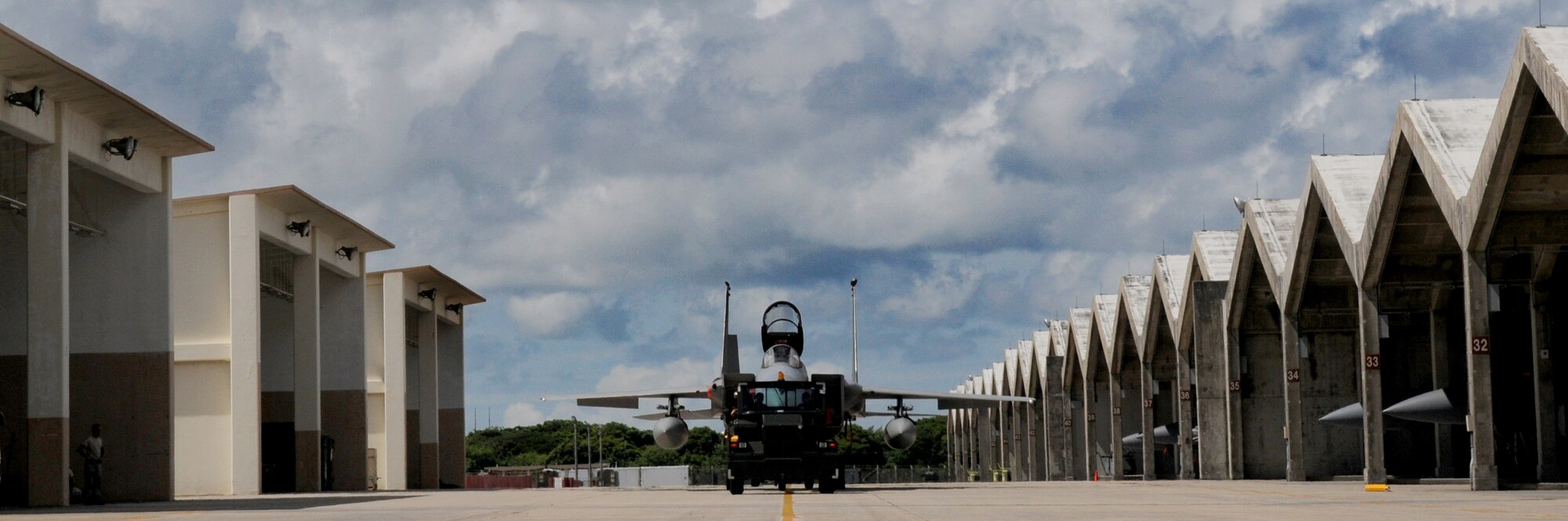 An F-15 from Kadena Air Base, Japan is towed to a storage location where it will be shielded from Typhoon Kompasu, Aug. 30. During inclement weather such as a typhoon, aircraft and aerospace ground equipment is placed in storage for protection. (US Air Force photo/Staff Sgt. Christopher Hummel)