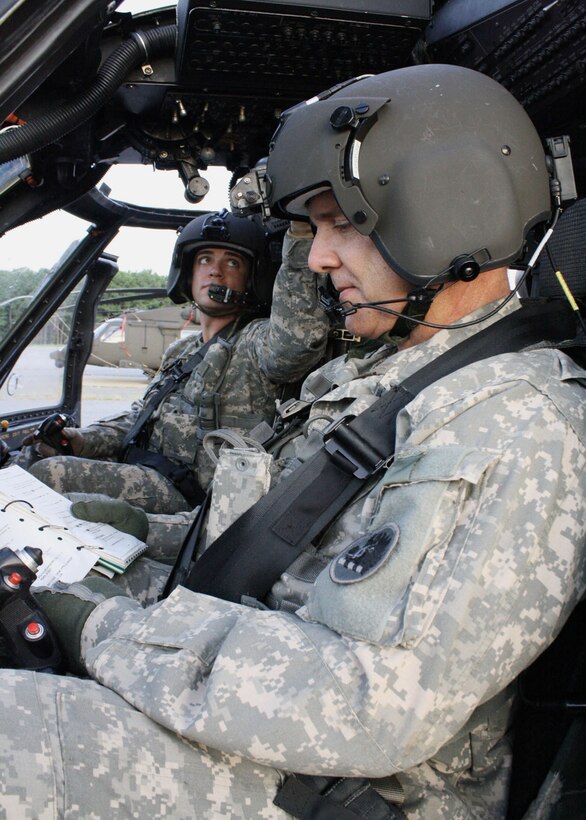 Army Chief Warrant Officer 5 Gary Button reads the preflight checklist