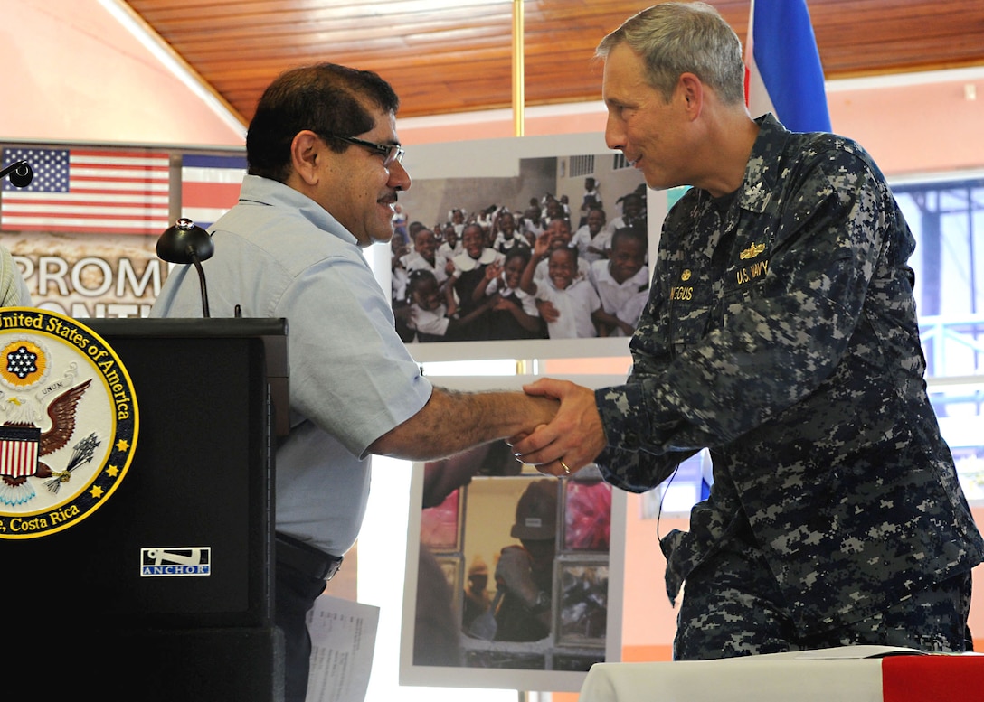 U.S. Navy Capt. Thomas Negus, left, commodore of Continuing Promise 2010, meets with the mayor of Limon, Costa Rica, Eduardo Barboza, during the opening ceremony for Continuing Promise 2010, Aug. 21, 2010. Iwo Jima is on a port visit to Limon conducting the Continuing Promise humanitarian civic assistance mission. The assigned medical and engineering staff embarked aboard Iwo Jima will work with partner nation teams to provide medical, dental, veterinary and engineering assistance in eight different nations.