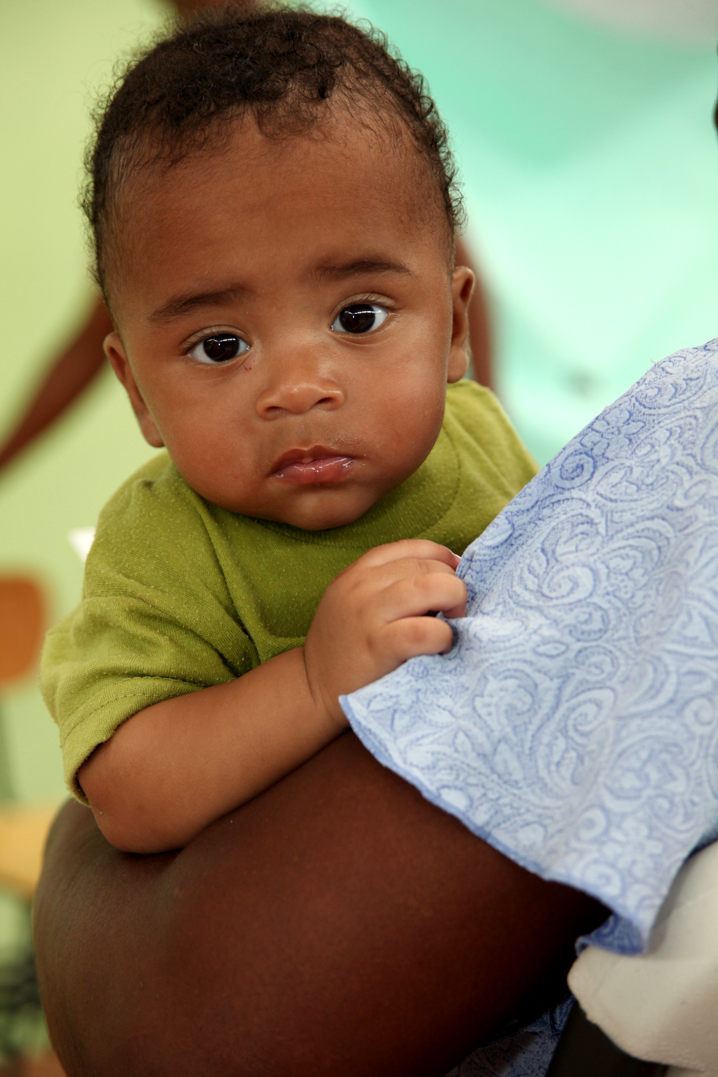 A Costa Rican Baby Waits With His Mother For Medical Treatment In A High School Gymnasium