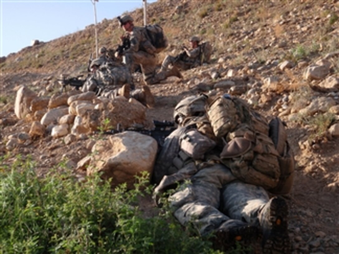 U.S. Army paratroopers with 1st Battalion, 503rd Infantry Regiment, 173rd Airborne Brigade Combat Team provide security halfway up a mountain as they move toward an objective in Jaghatu district, Wardak province, Afghanistan, on Aug. 21, 2010.  