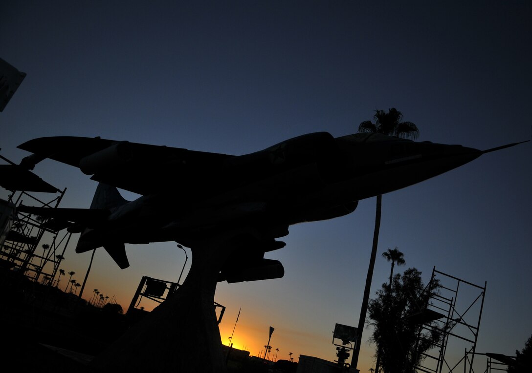 A static display of an AV-8 Harrier in the process of being restored stands against the sunset at the Marine Corps Air Station in Yuma, Ariz., Aug. 30, 2010. The refurbishing process was done by shifts of Marine Attack Squadron 513 Marines, who oversaw and facilitated the restoration, which consisted of power washing and painting the aircraft. There’s a sense of accomplishment in restoring an aircraft that once belonged to your squadron, said Sgt. Jason Vanzile, VMA-513 airframes mechanic.