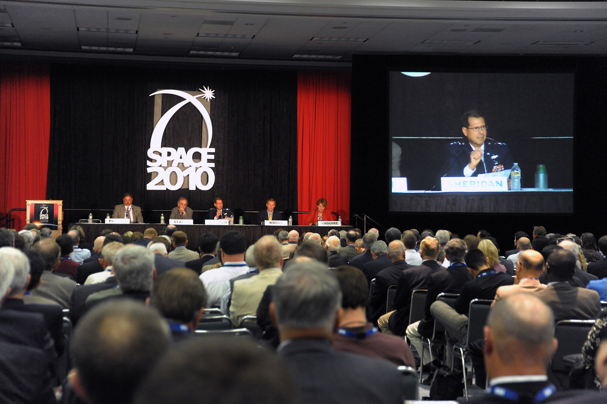 Panel members speak to the crowd at the opening session of AIAA's Space 2010 conference in Anaheim, Aug. 31. This year's conference theme is Space: Imagine, Innovate, Collaborate. Pictured from left to right are: Elliott Pulham, Space Foundation CEO; Charles Elachi, NASA Jet Propulsion Laboratory director; Lt. Gen. Tom Sheridan, SMC commander; Roger Krone, Boeing Network and Space Systems president; and Joanne Maguire, Lockheed Martin executive vice president. (Photo by Joe Juarez)