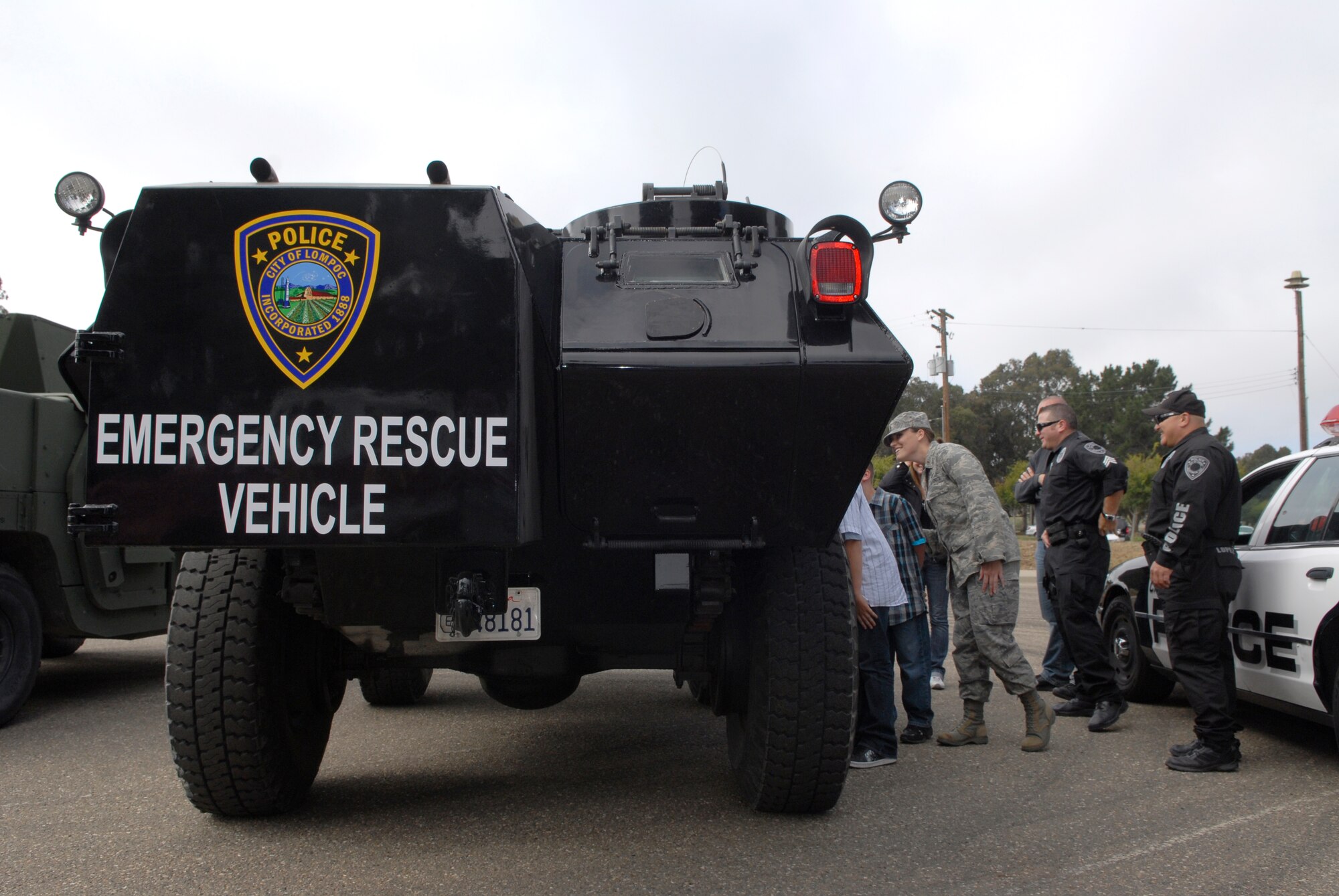 VANDENBERG AIR FORCE BASE, Calif. -- Members from the base take a peek at the Lompoc Police Department's V100 armored personnel carrier here Friday, Aug. 27, 2010.  Law enforcement agencies from the local area and the  base participated in National Night Out Against Crime event to educate people on deterrence and crime prevention.  (U.S. Air Force photo/Senior Airman Andrew Satran) 

 