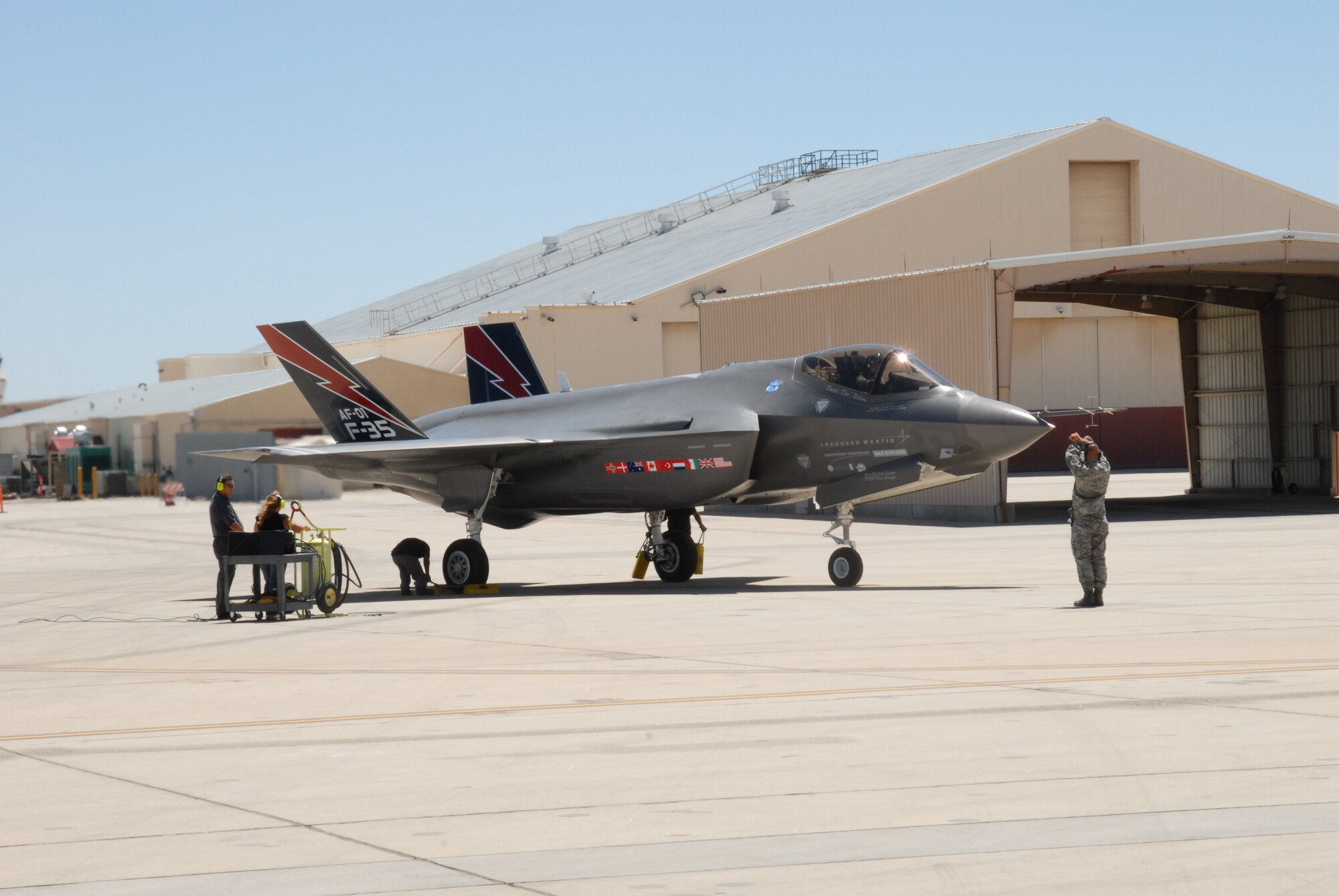 An F-35 Lightning II, one of two at Edwards currently used for developmental testing, sits in front of Hangar 1820.  Photographers were allowed to take photos of the 5th generation fighter for a media event.  The event showcased the developmental testing and evaluation process at Flight Test Nation.  (Air Force photo by Stephen K. Robinson)